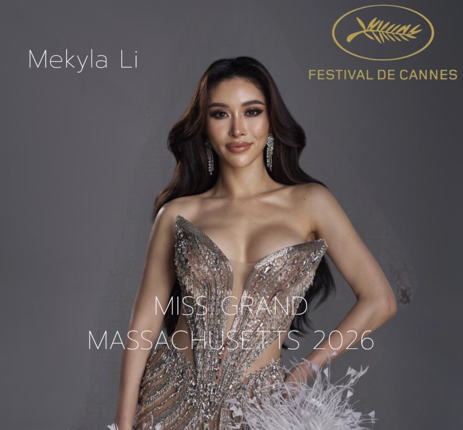 A woman in an elegant dress and long earrings poses for a photo at the Miss Grand Massachusetts 2026 event, with text and logos related to the competition.