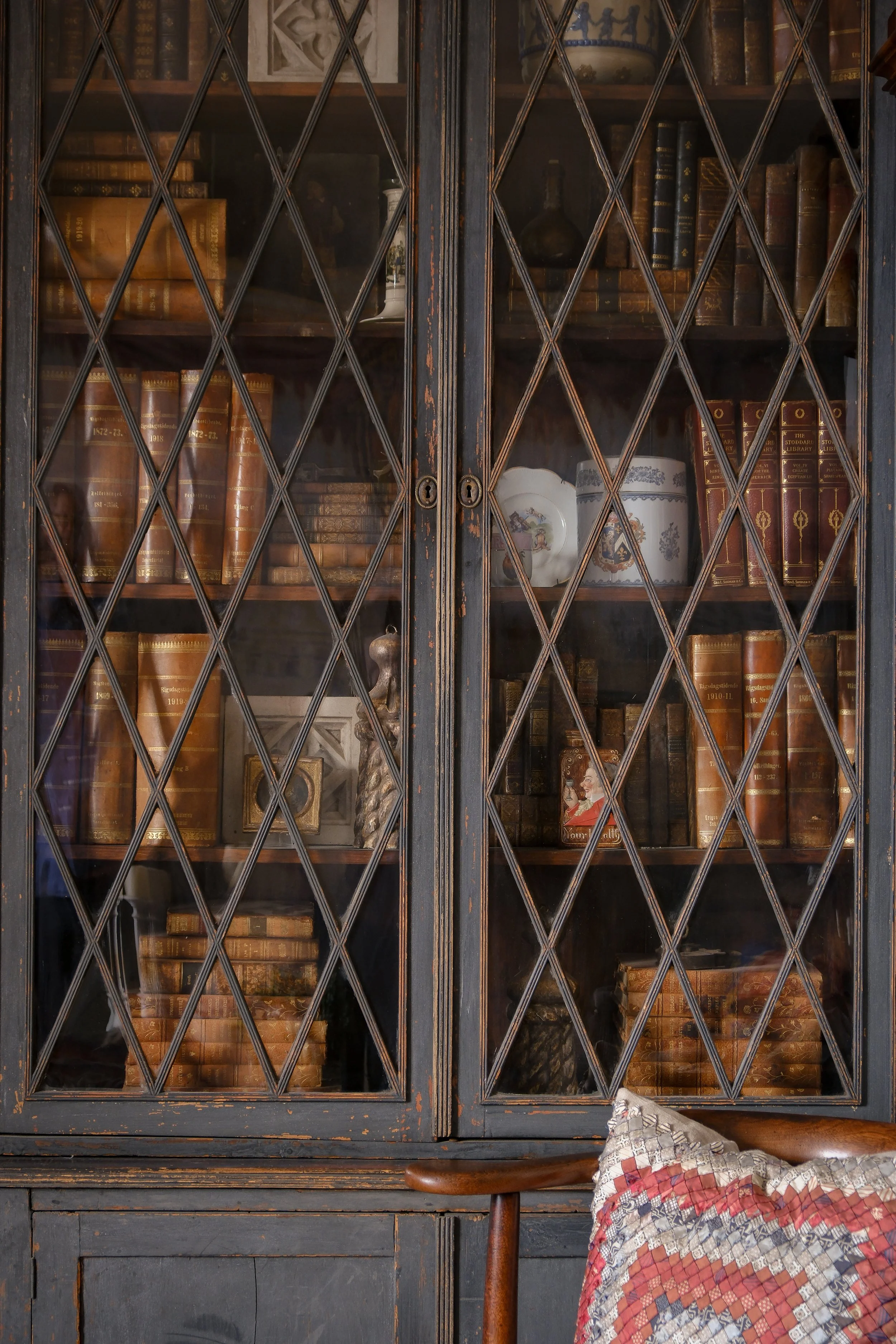 Antique-filled bookcase at Lee Stanton Laguna Beach home