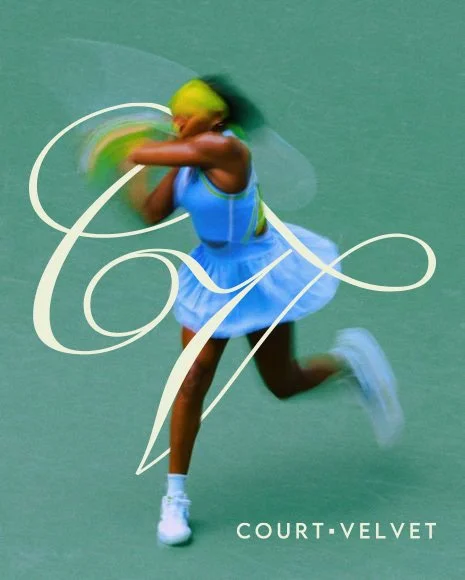 A female tennis player with yellow hair wearing a blue tennis dress and white shoes, swinging a tennis racket on a green court with a decorative white monogram and the words "Court Velvet".