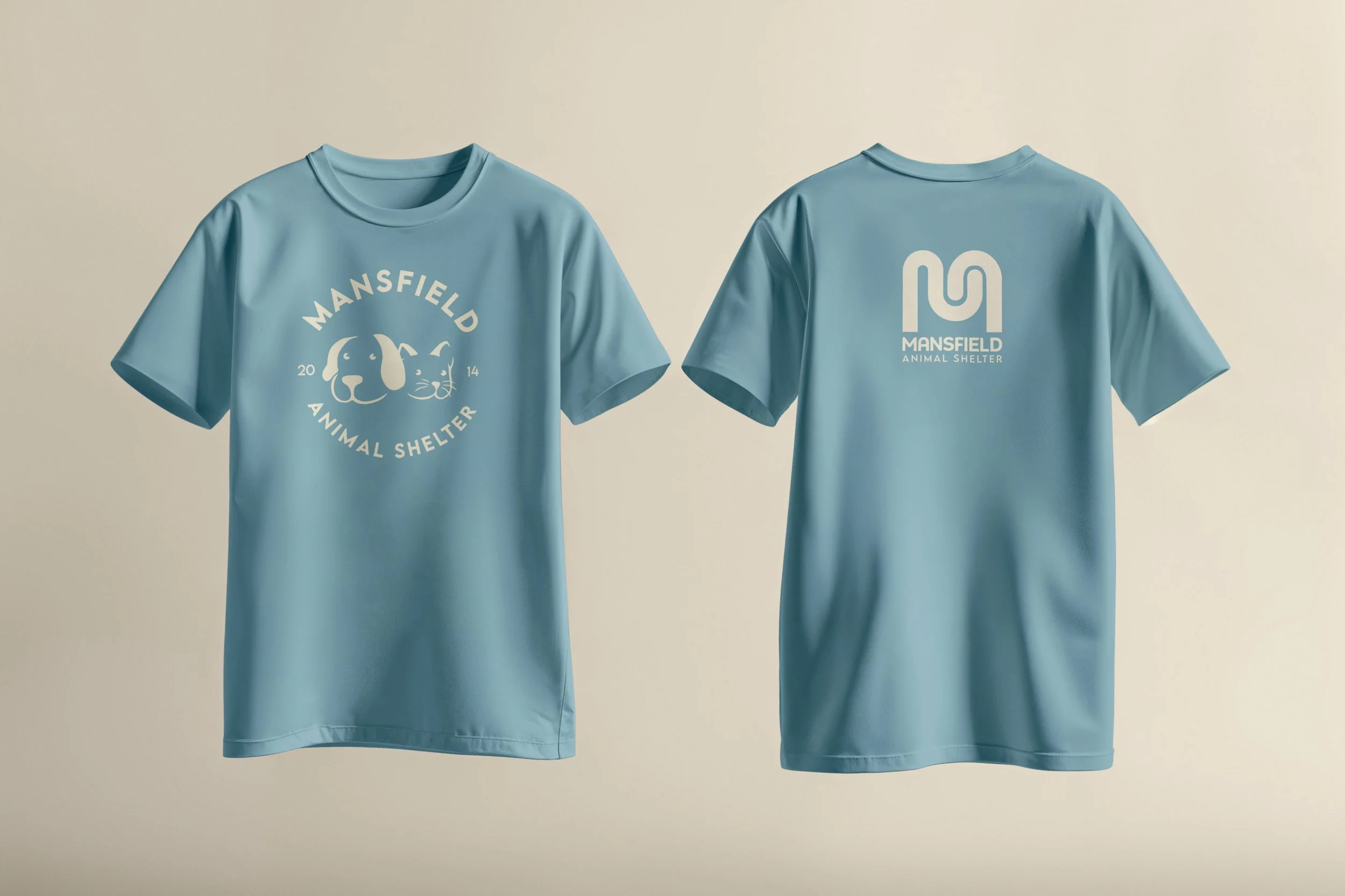 Light blue T-shirt with white graphic of a dog and a cat, and text for Mansfield Animal Shelter, with the number 10 on the back.