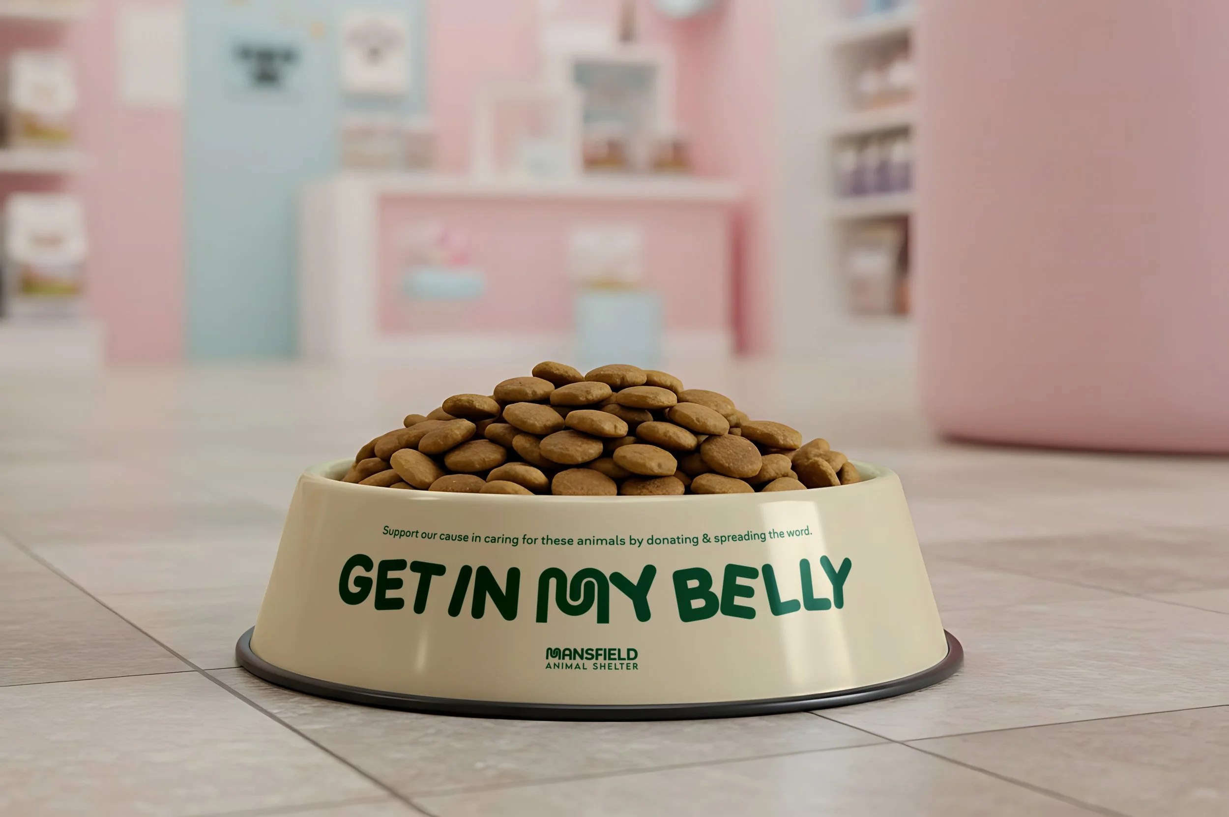 A bowl of pet food with the words "Getting my belly" visible, placed on a tiled floor in front of a pastel pink and blue room, likely at an animal shelter.