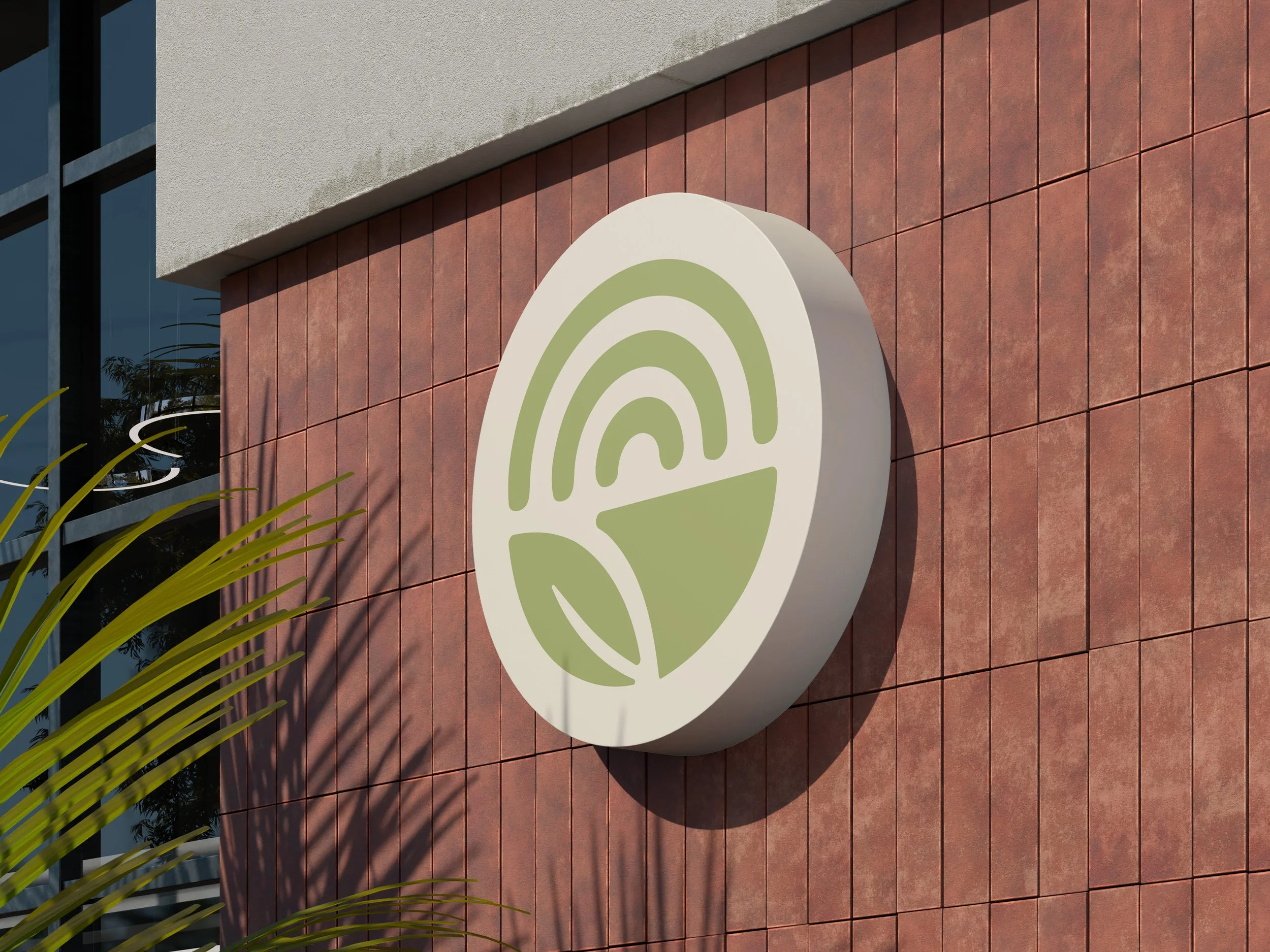 A large round sign for Echo with a green leaf icon mounted on a red brick wall outside a building.