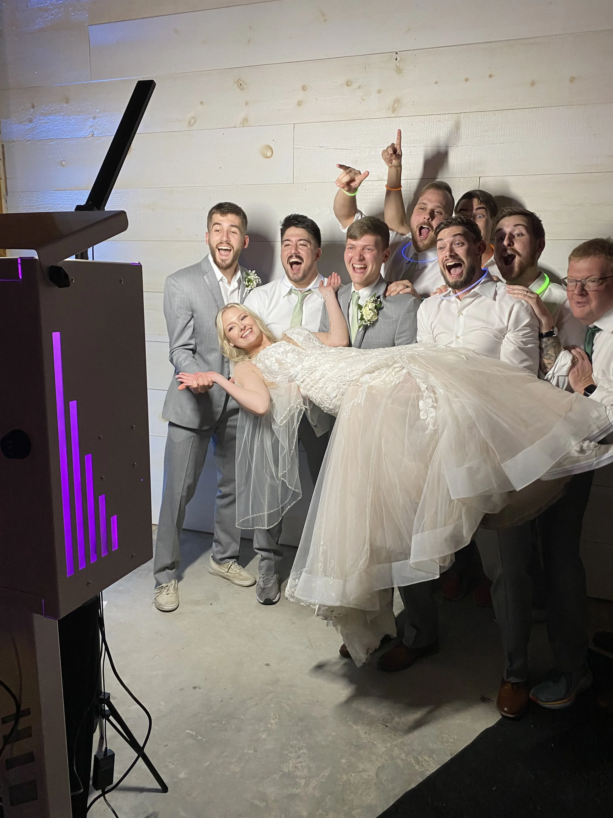 Bride having great time with custom photobooth during wedding