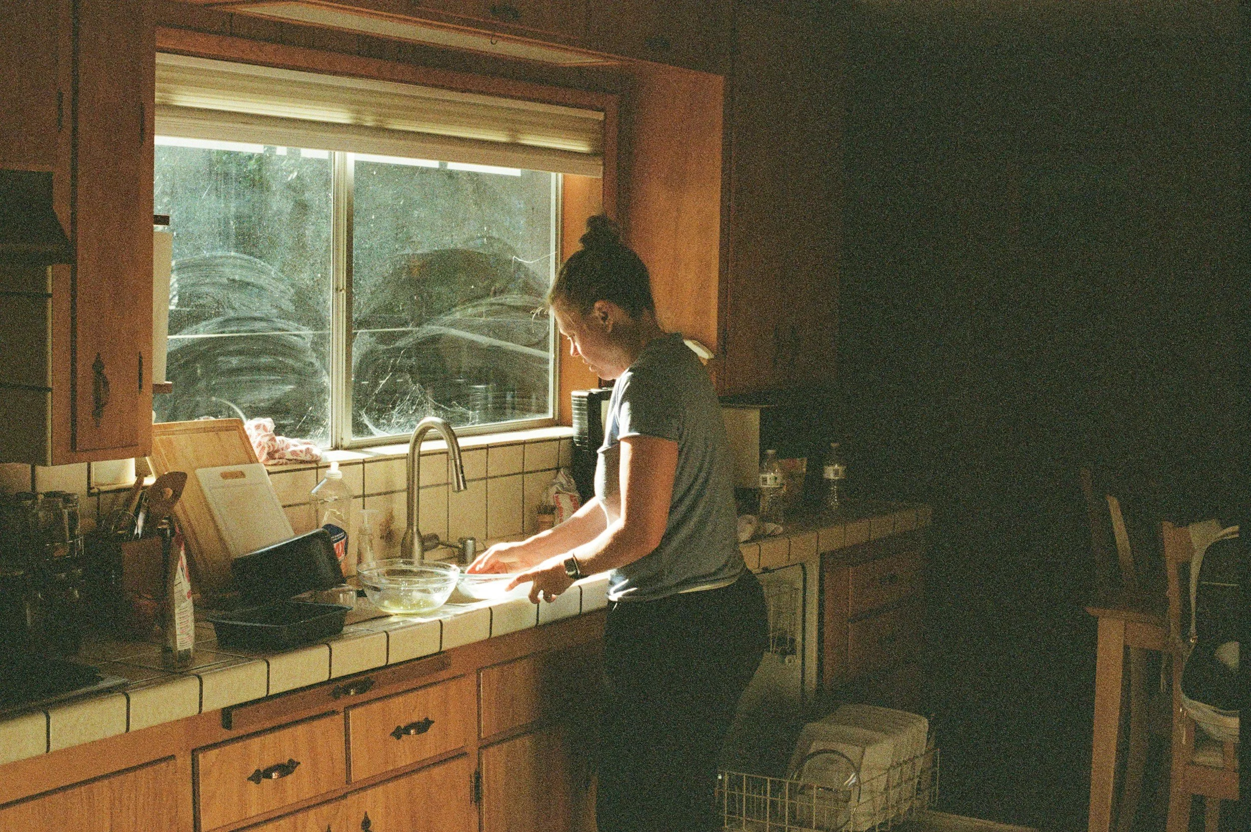 woman with ADHD cleaning her kitchen