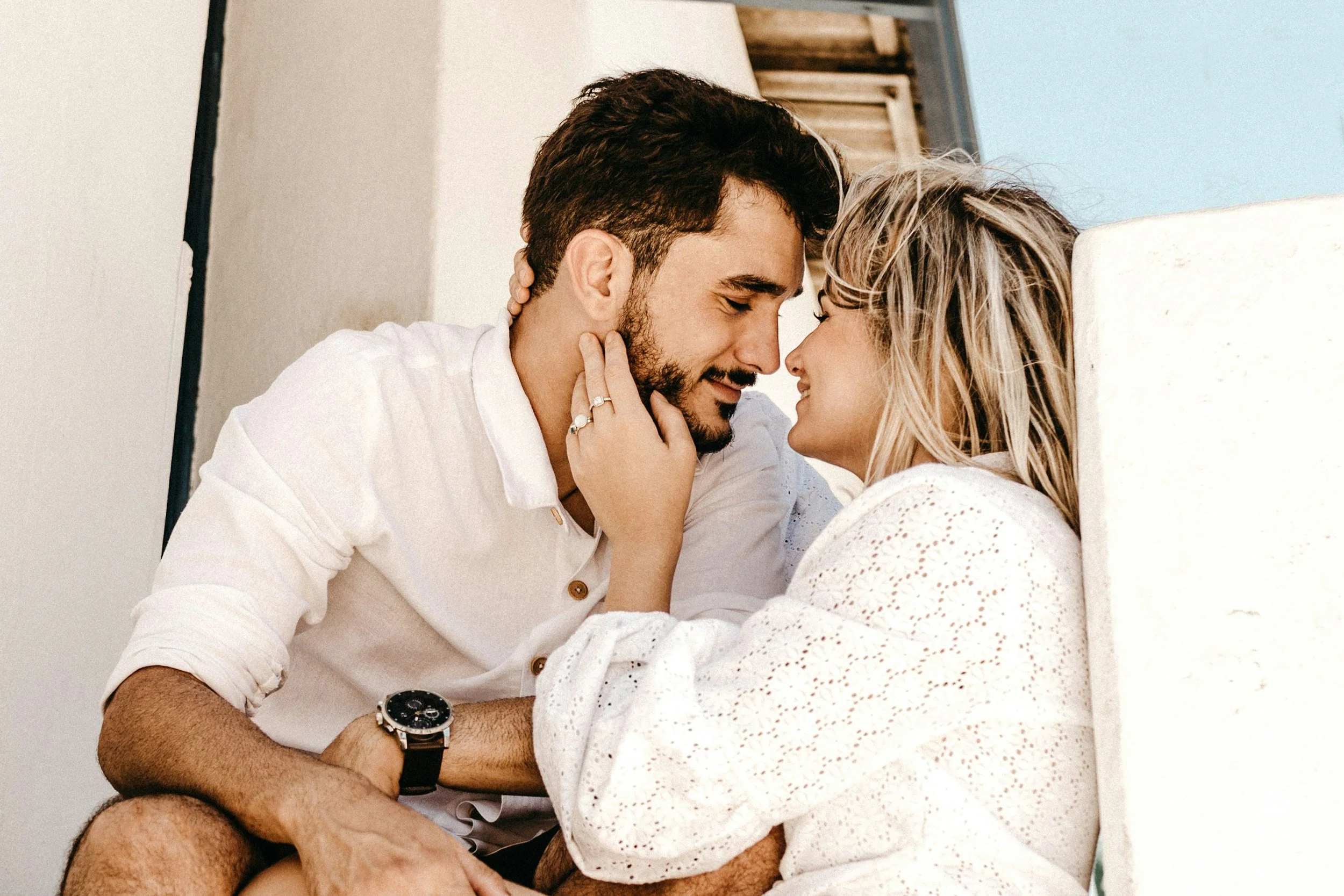 A couple reconnecting and woman touching the man's face