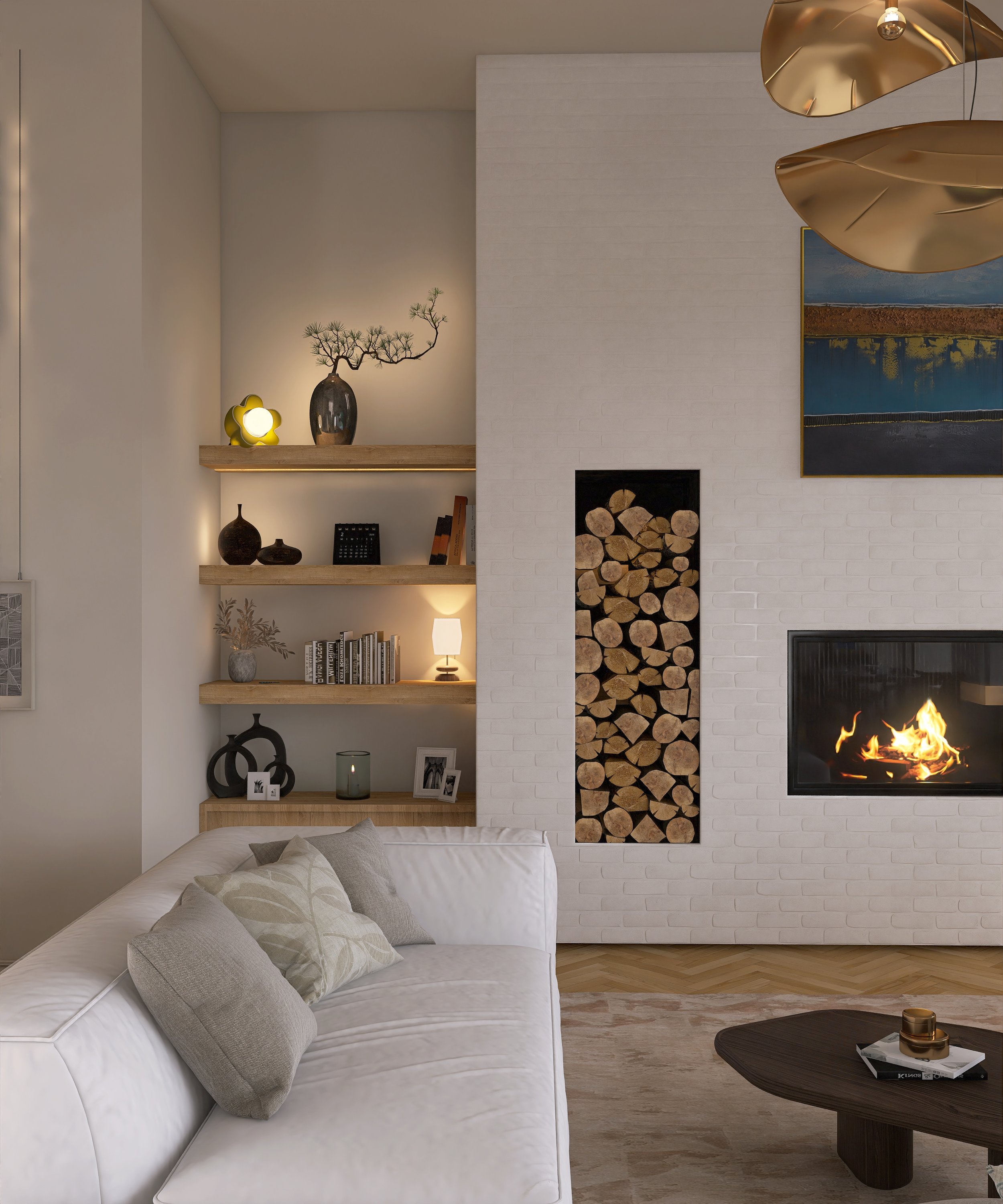 Modern living room with white sectional sofa, gray throw pillows, floating wooden shelves decorated with vases, books, small artwork, and a lamp, brick fireplace with stacked firewood, abstract painting, and a hanging gold sculpture, with a black coffee table holding decorative items, and wood flooring.