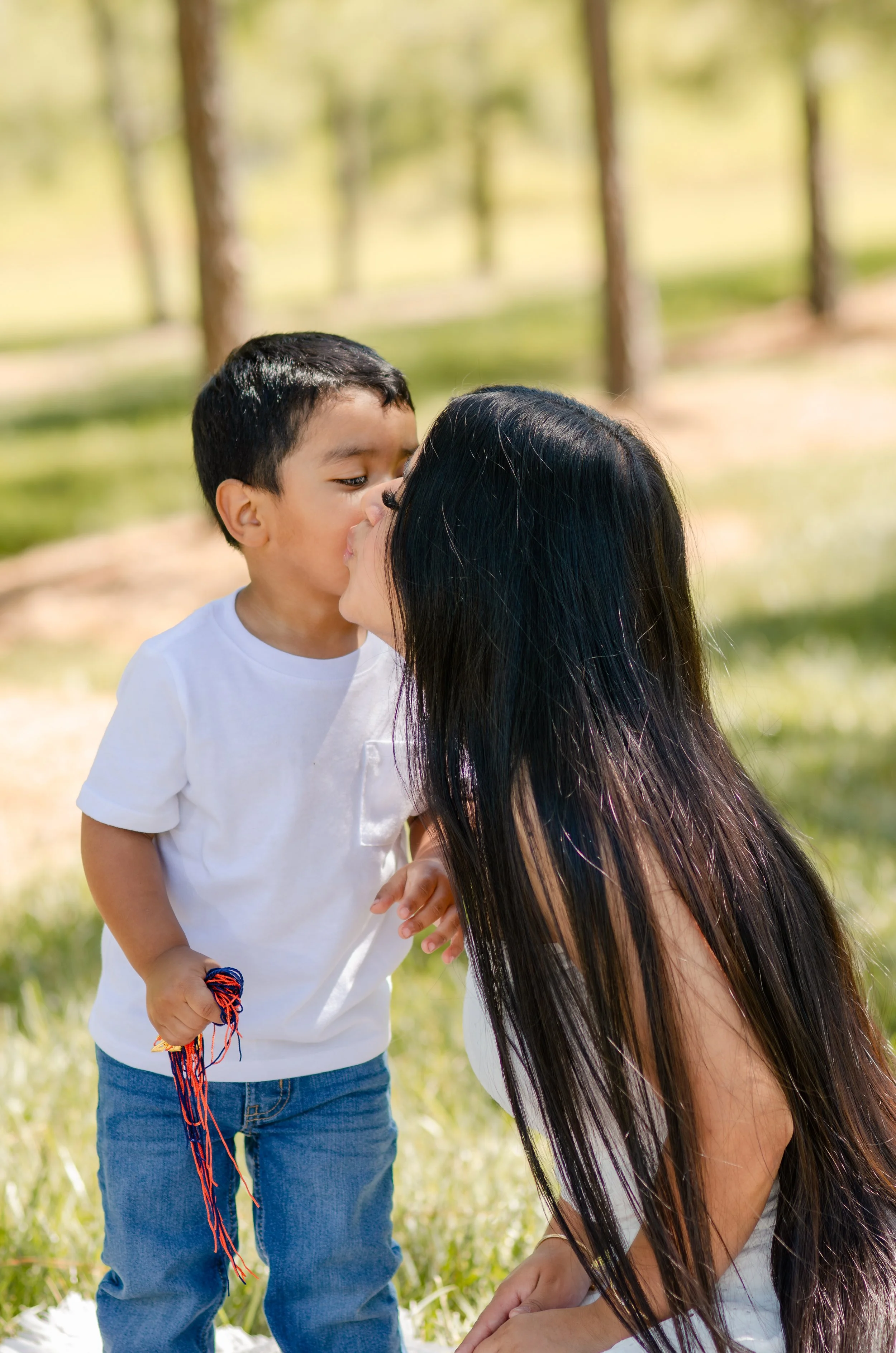  Mom holding her little boy during a light and airy outdoor mommy and son photo session in Knoxville, Tennessee 