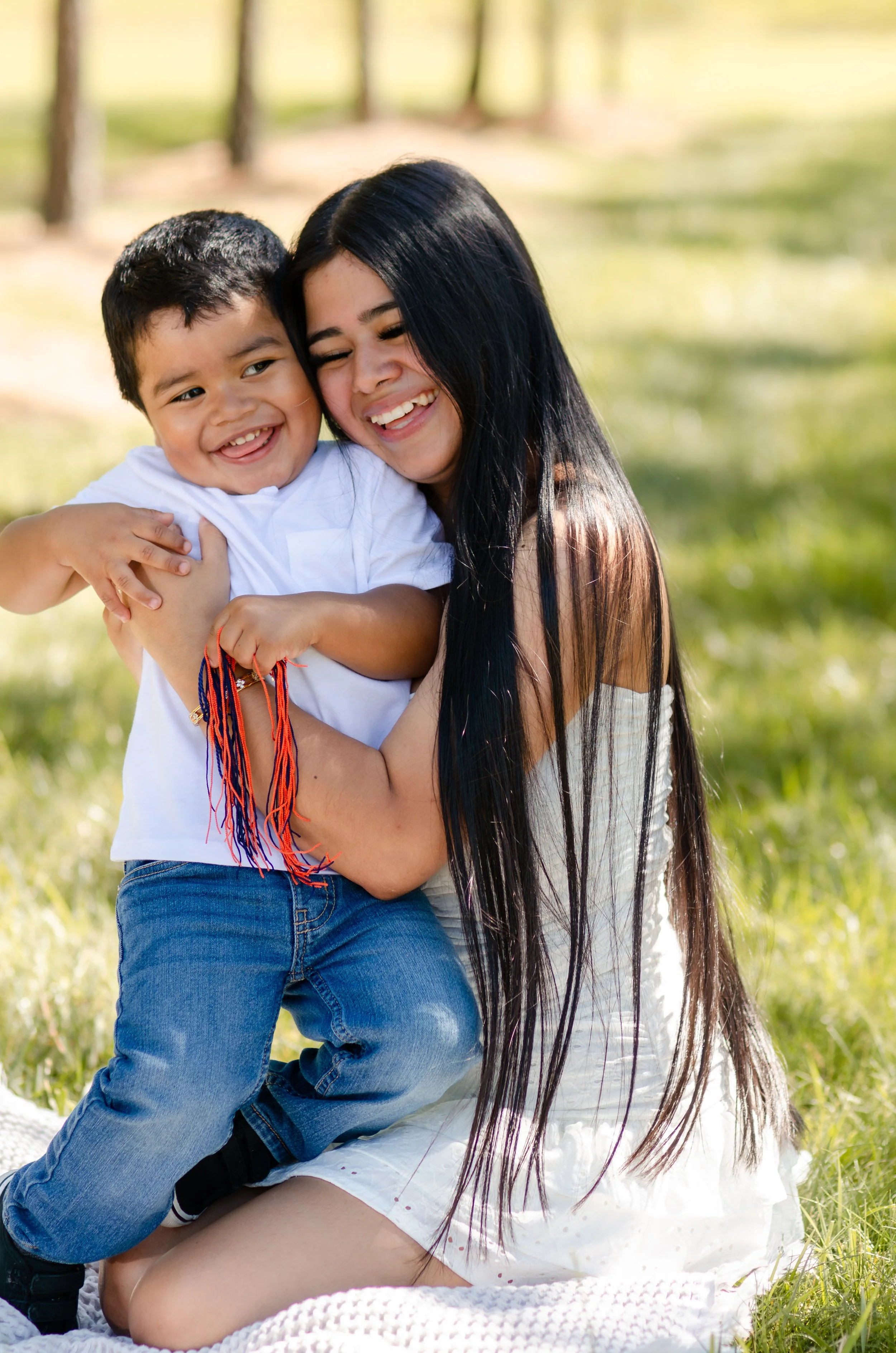  Emotional motherhood photography of a mom holding her little boy close during a dreamy sunset session 