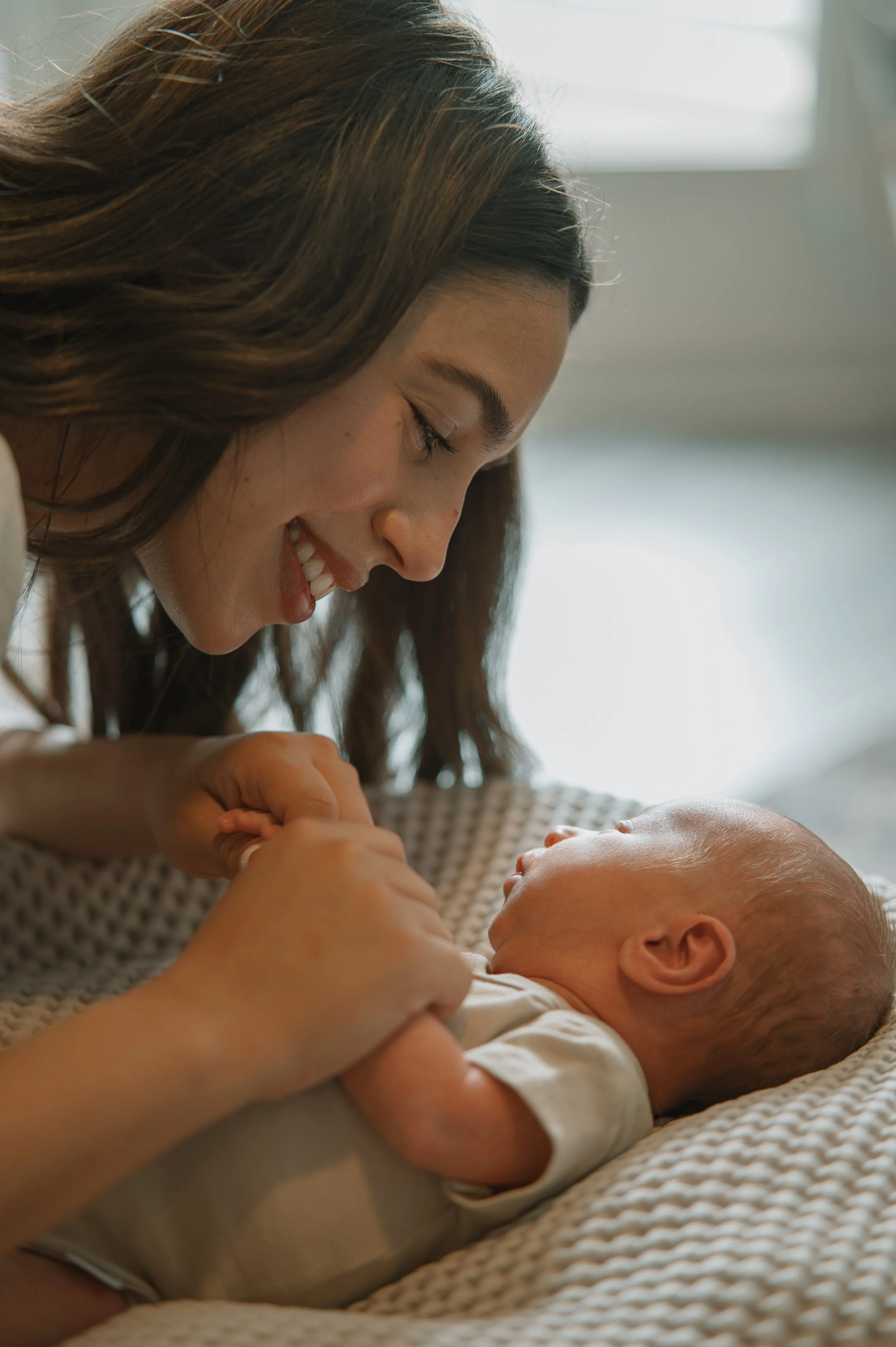 Mom admiring their newborn baby during an in-home session in Tennessee.