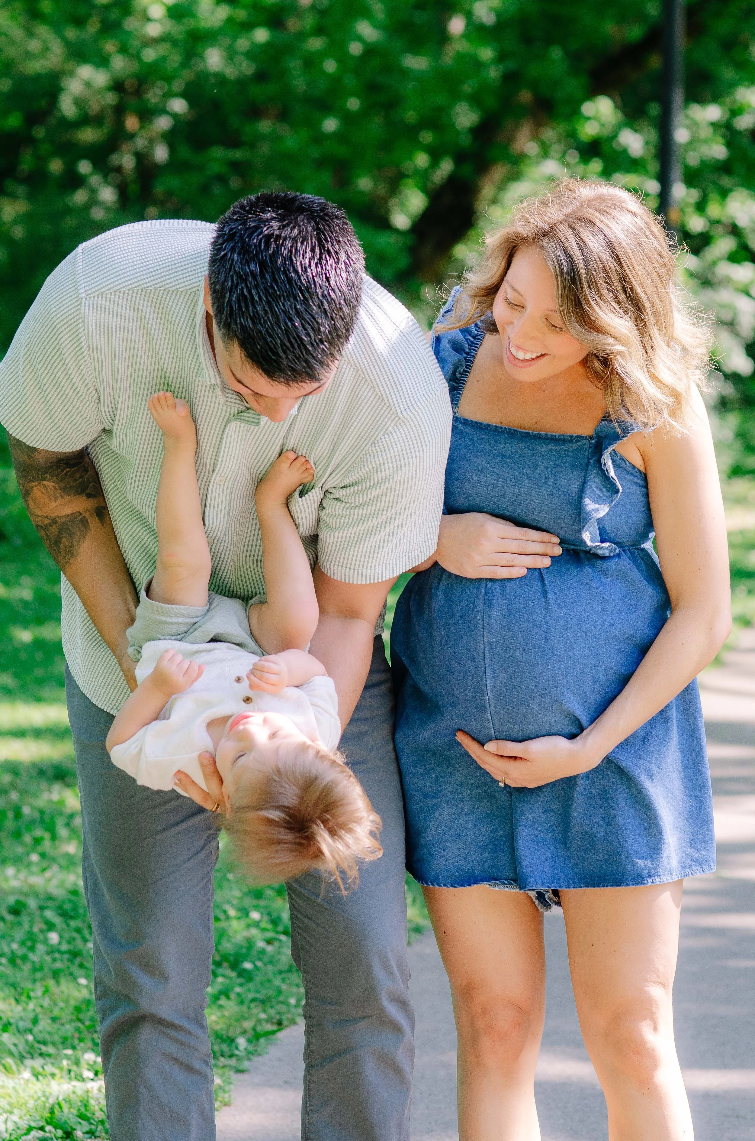Expecting mom and her family photographed outdoors during a maternity session at Sandy Springs Park in Maryville, TN.