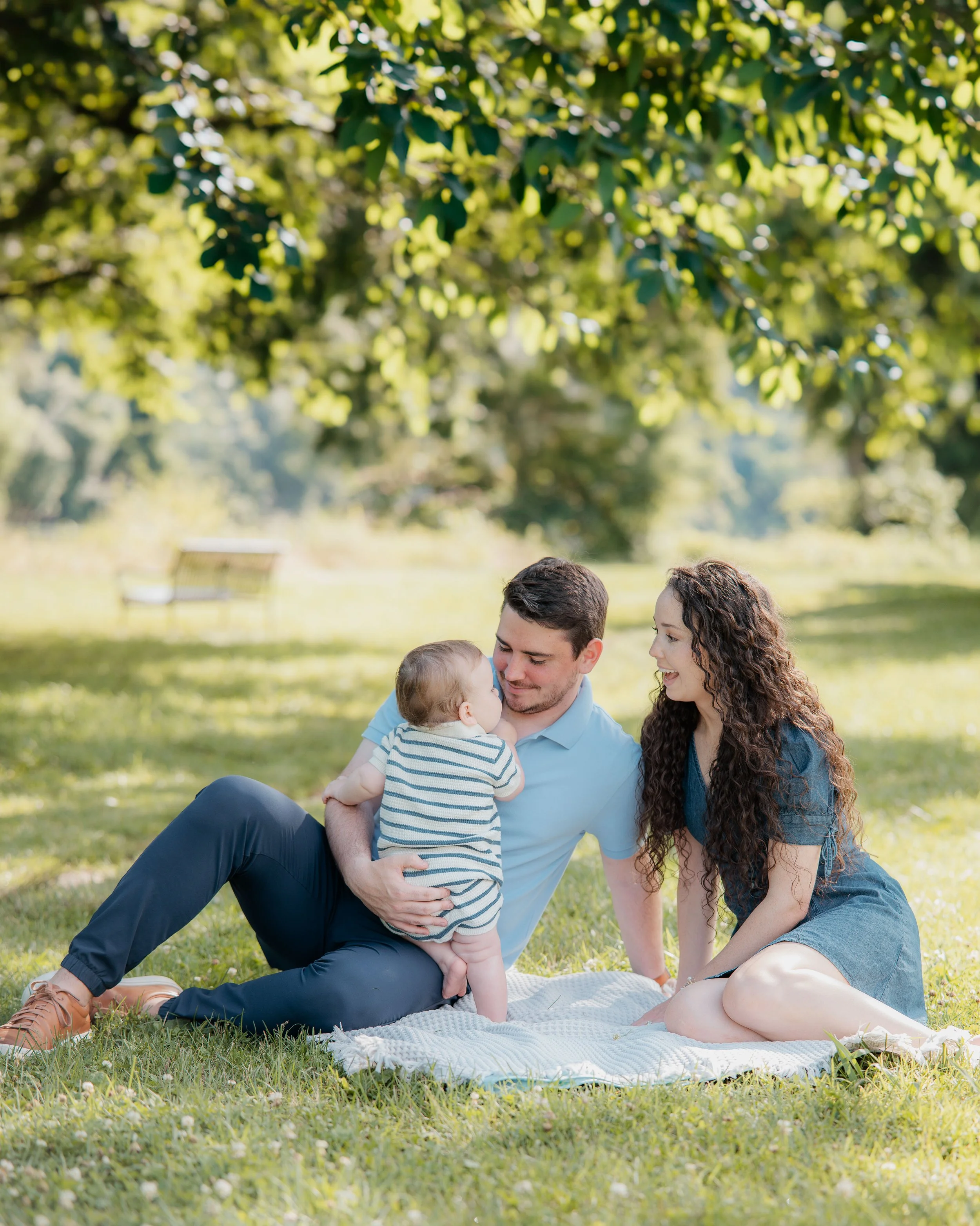Family cuddling on a blanket during golden hour in Knoxville TN