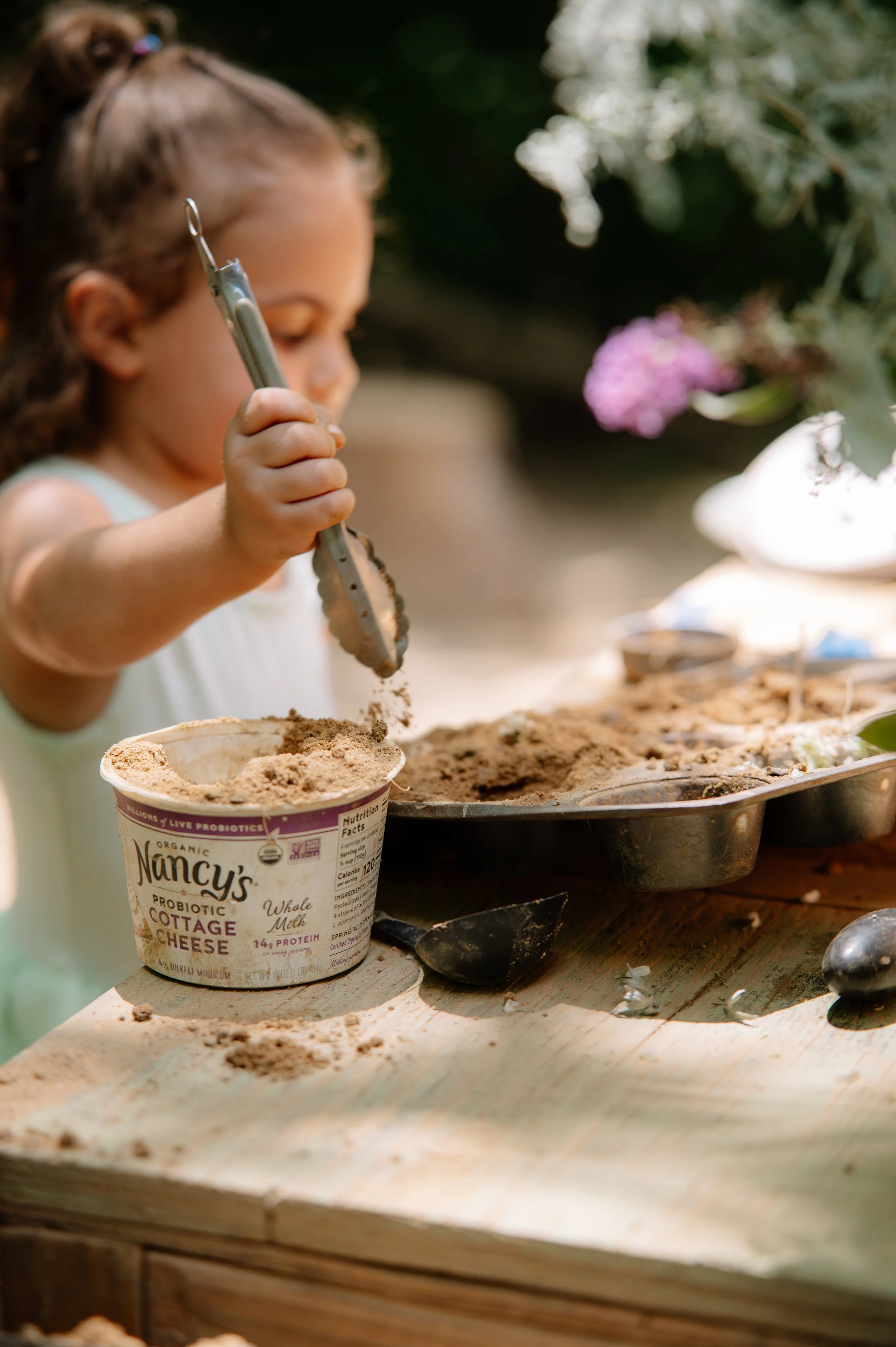 East Tennessee family photographer documenting childhood adventures in a forest mud kitchen