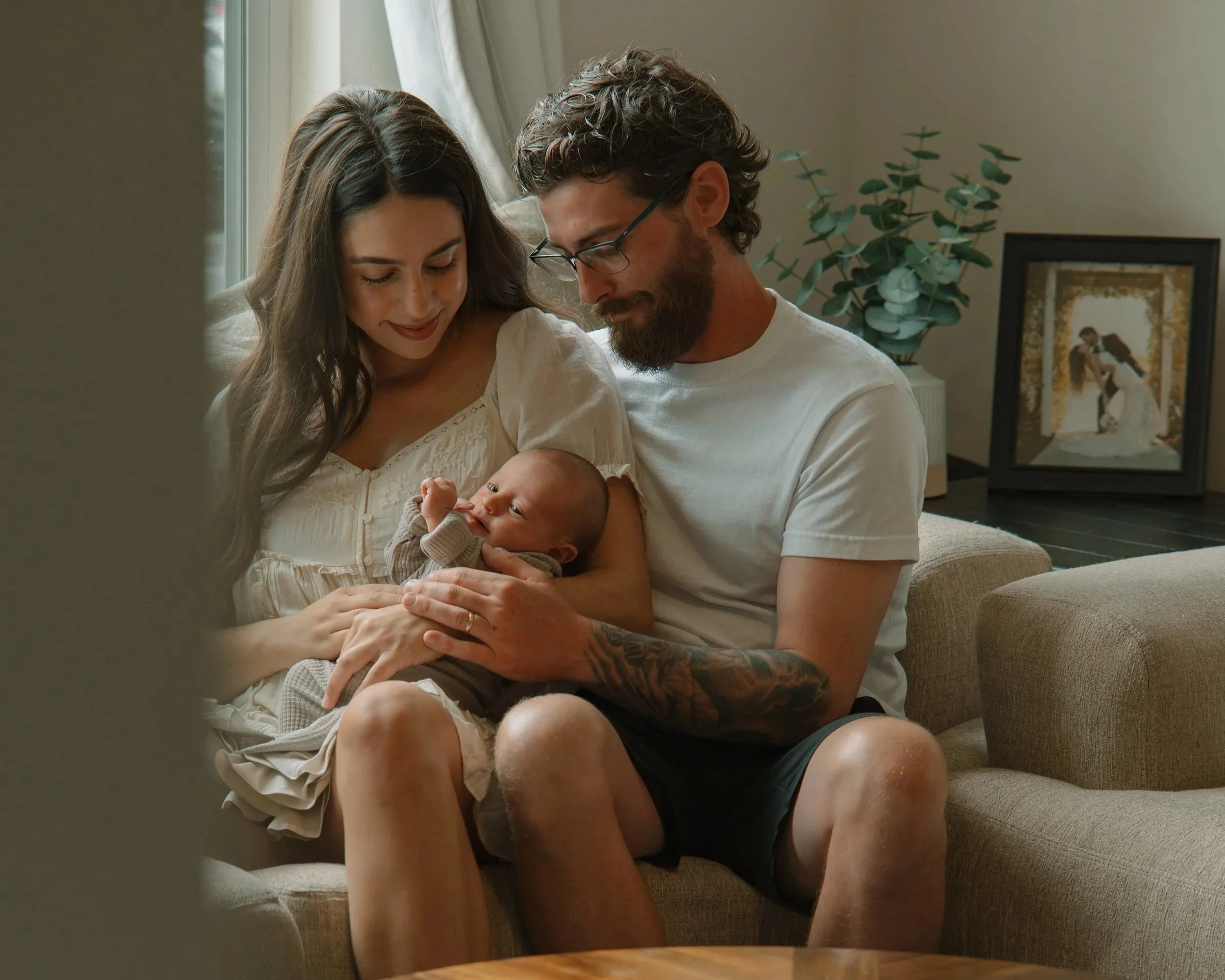Parents holding their newborn baby in a cozy Maryville home