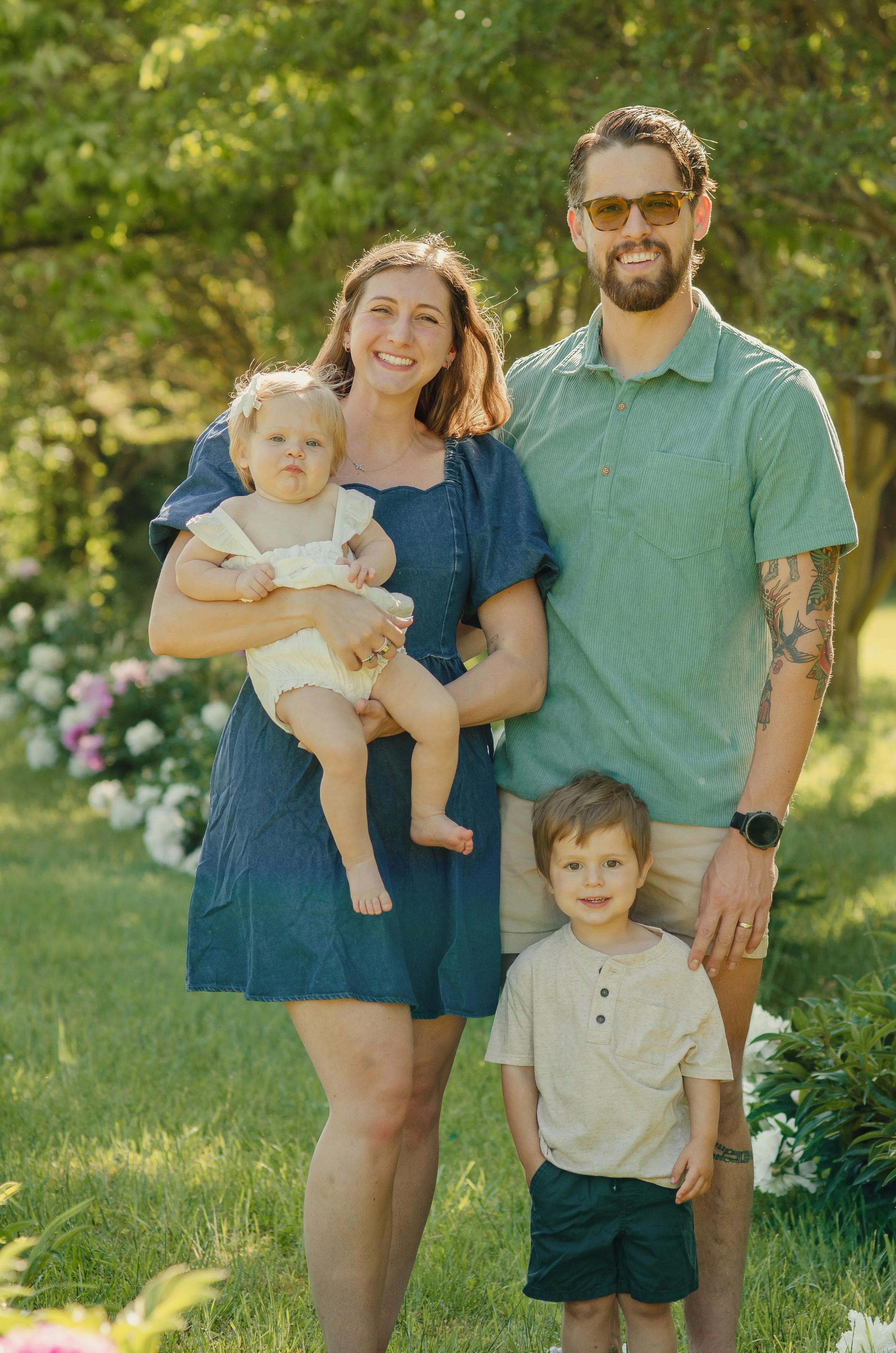 Mother and father holding hands with their two children during a family photography session in Maryville, Tennessee.