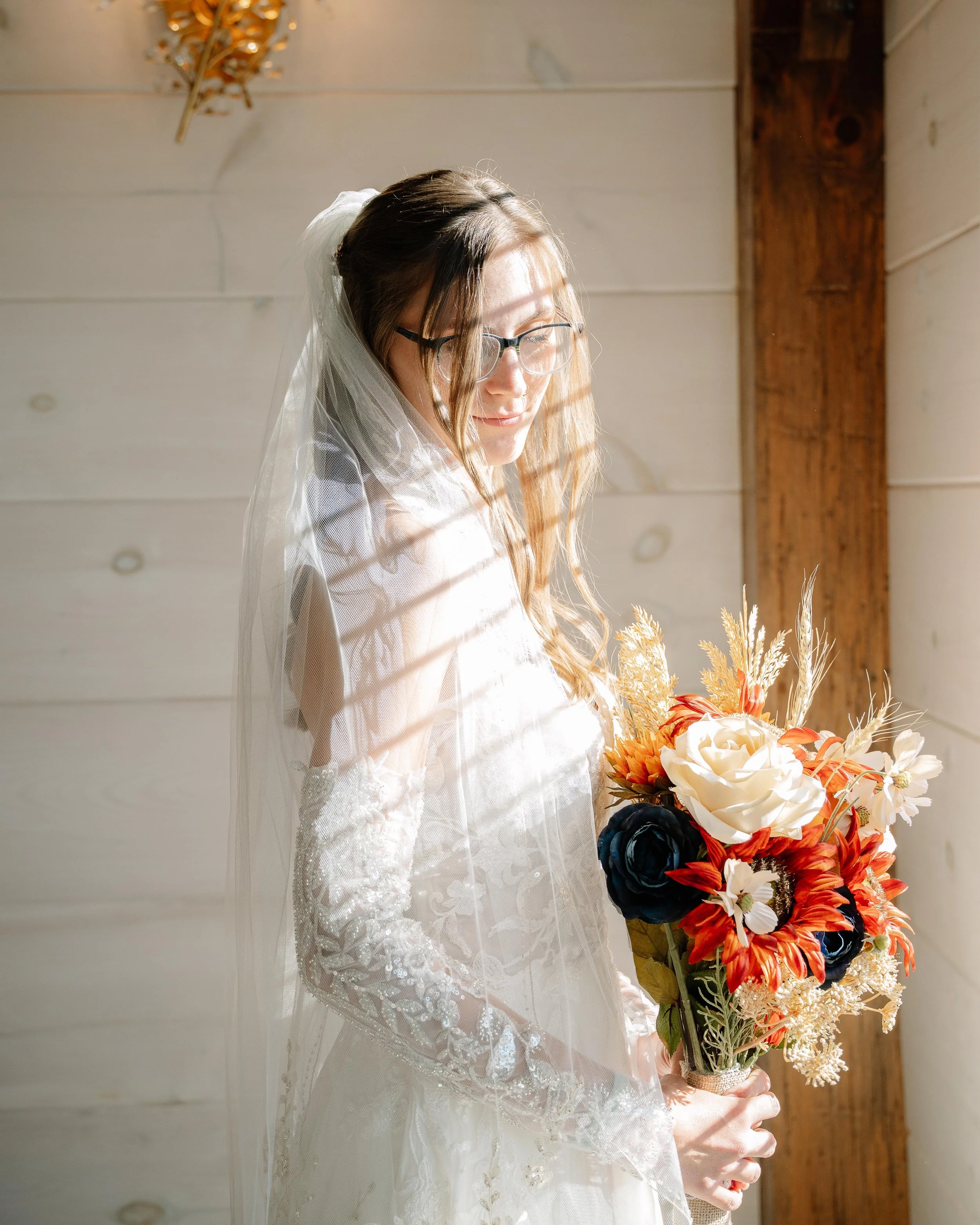 Natural wedding photography with bride posing in front of the window in Maryville Tennessee