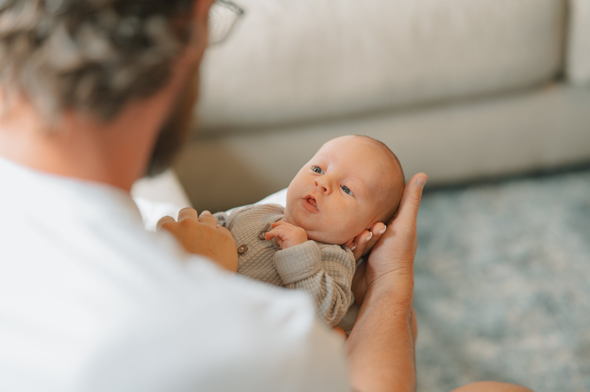 Relaxed family portraits with young children and newborn baby outdoors