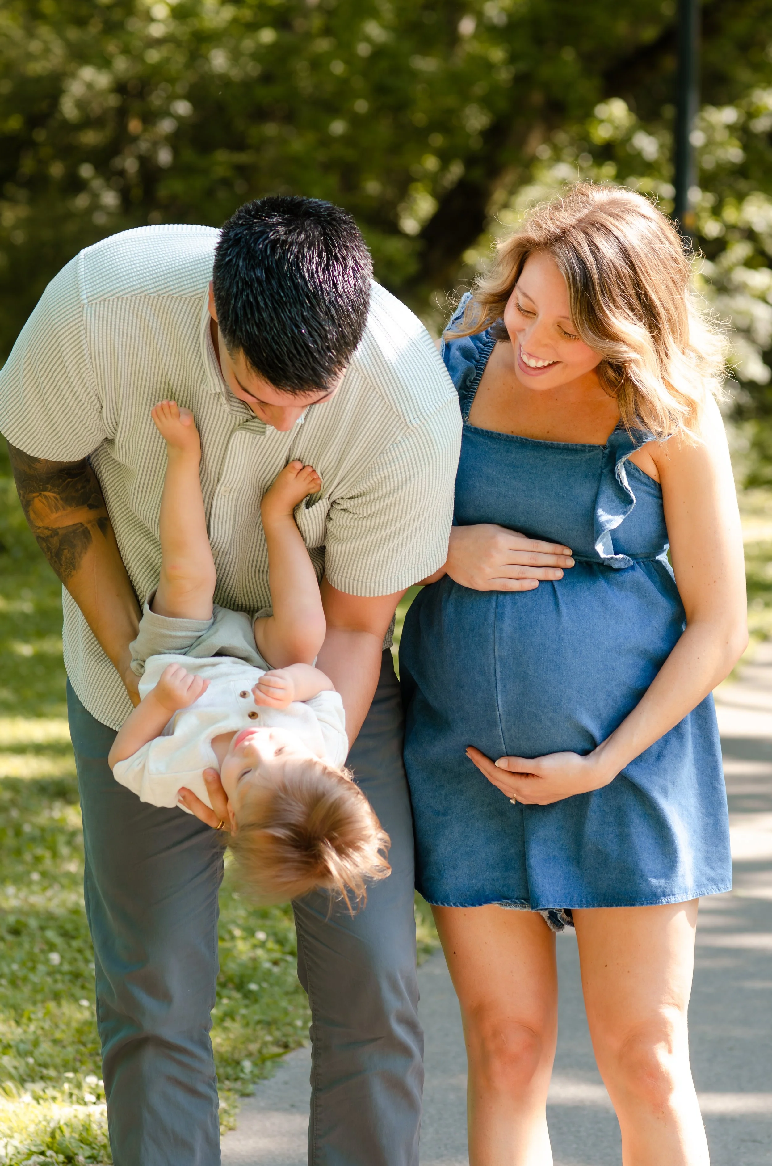 Family maternity session, including older siblings and a baby on the way, during a playful photography session in Maryville, TN