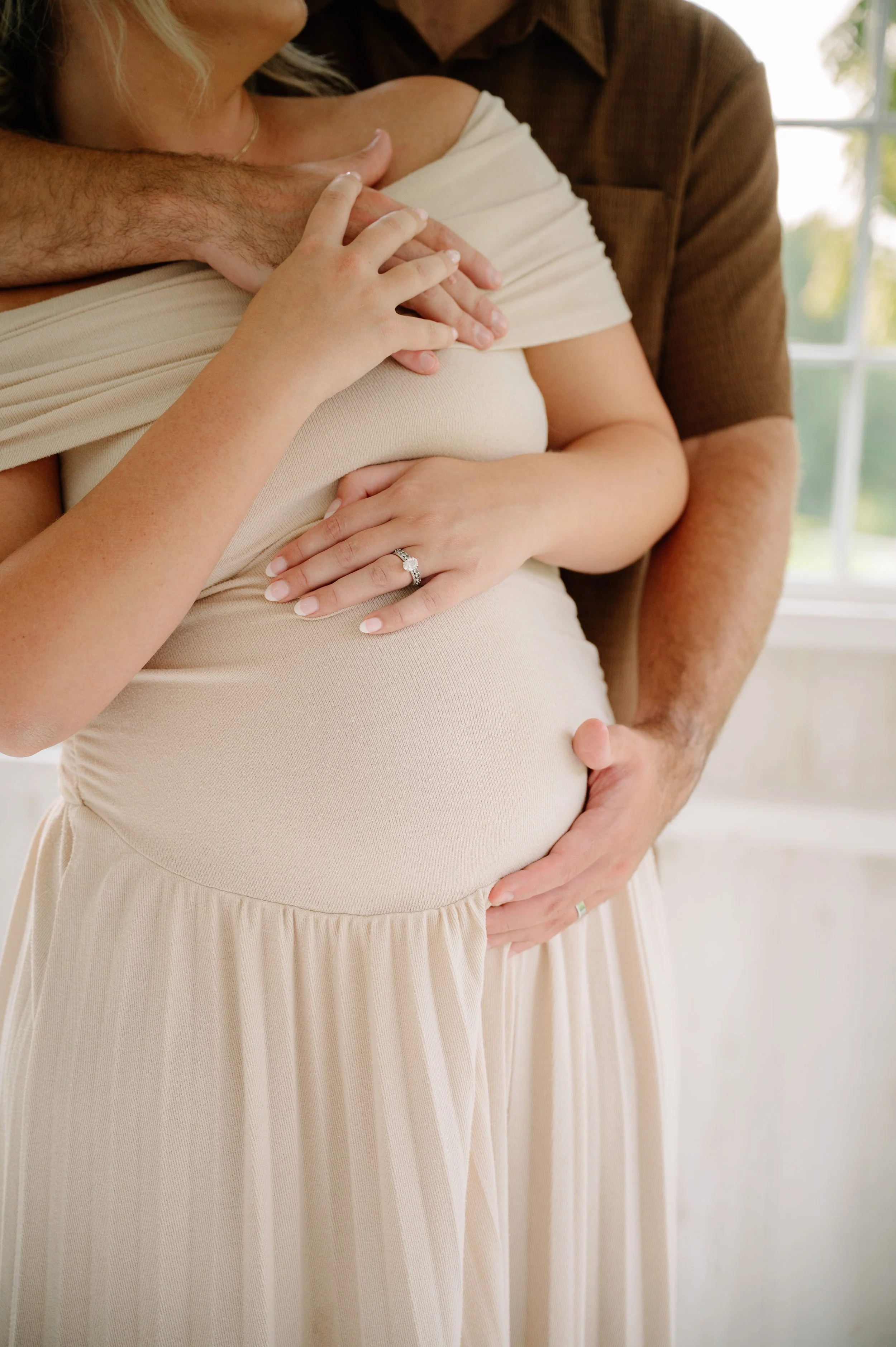 In-home newborn photography capturing small baby details with parents in Maryville 