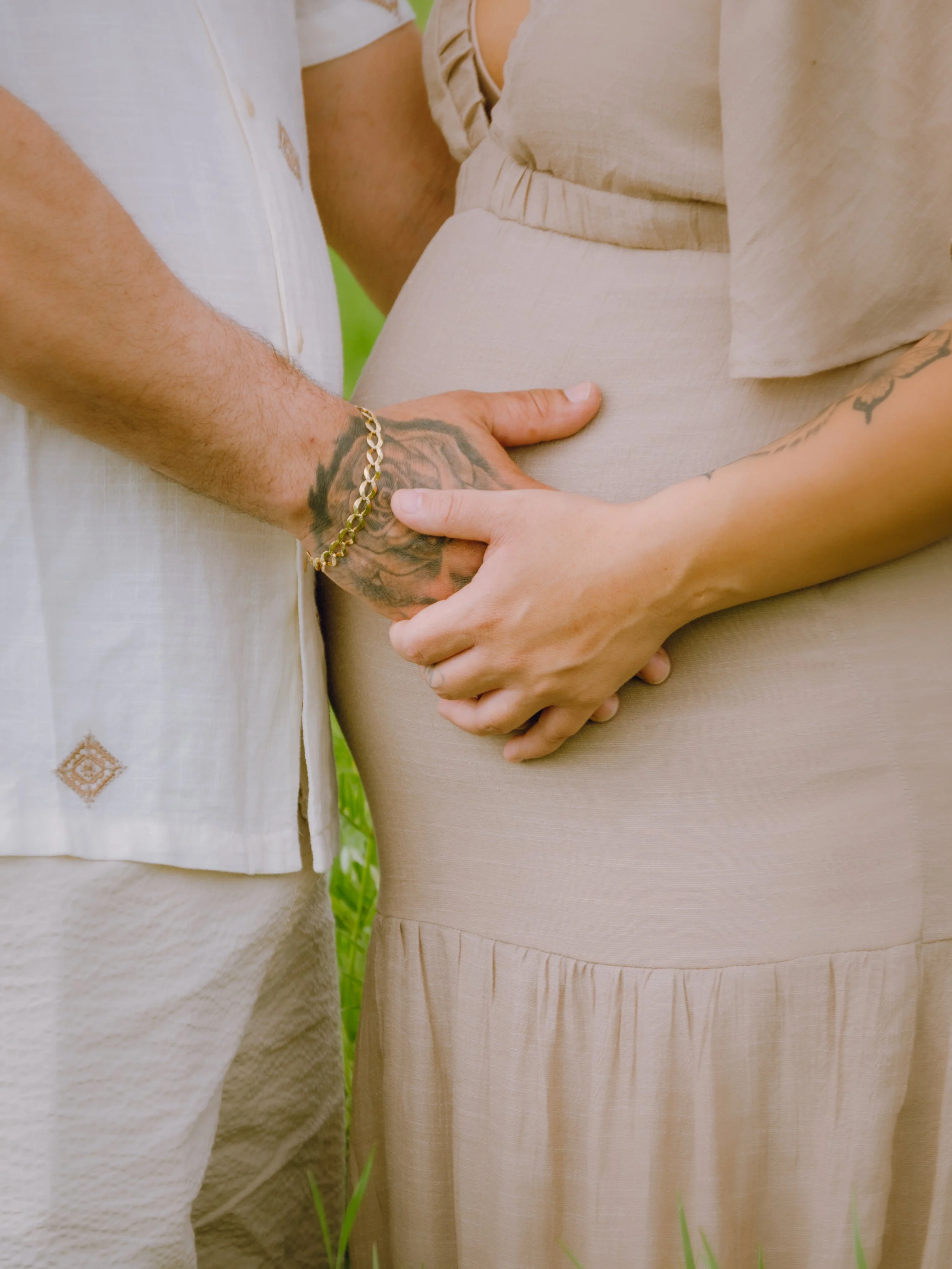 Outdoor maternity photography showcasing the beauty of motherhood, mom and dad holding hands