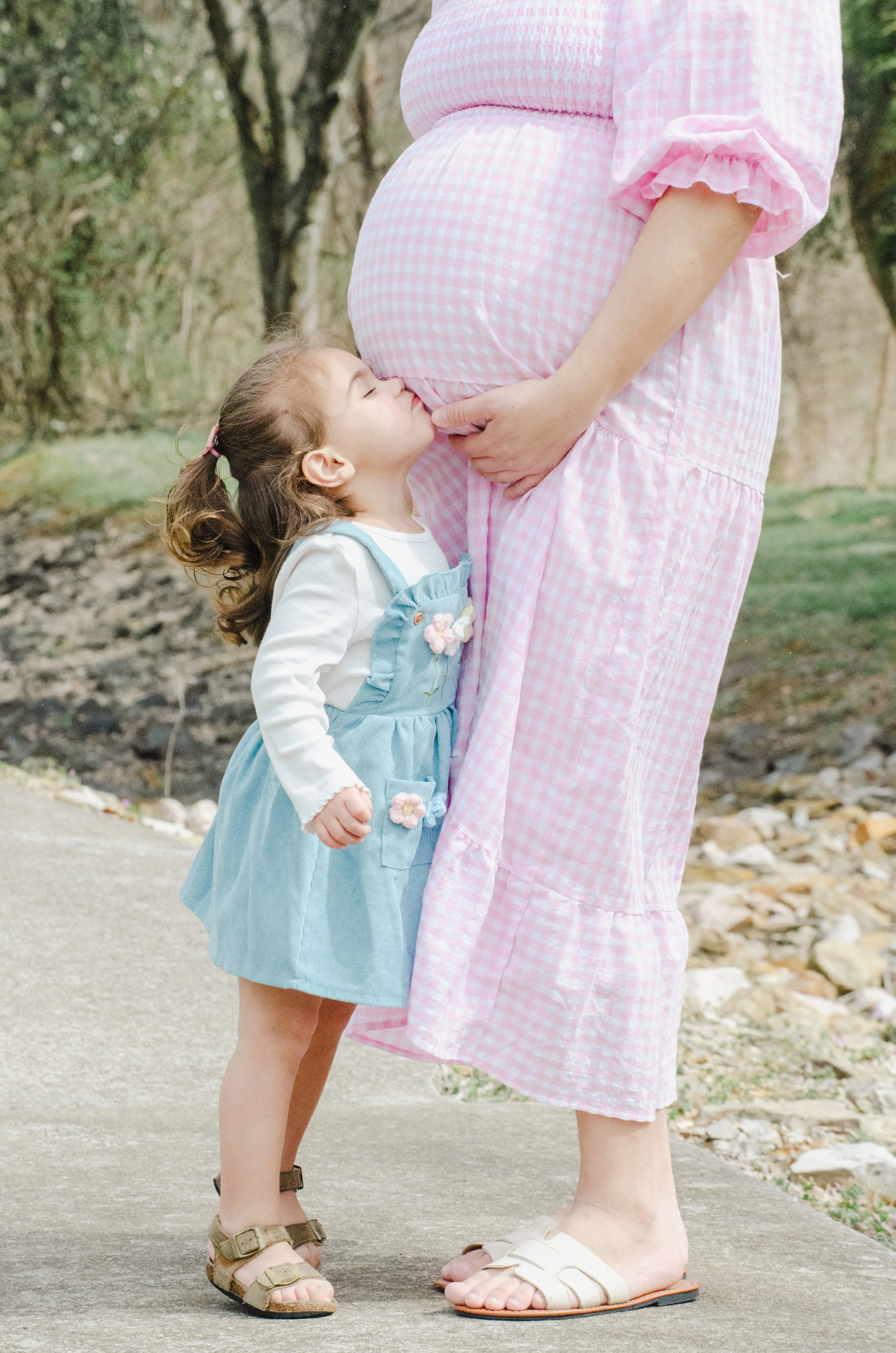 Outdoor maternity photos in Knoxville with kids interacting naturally with mom