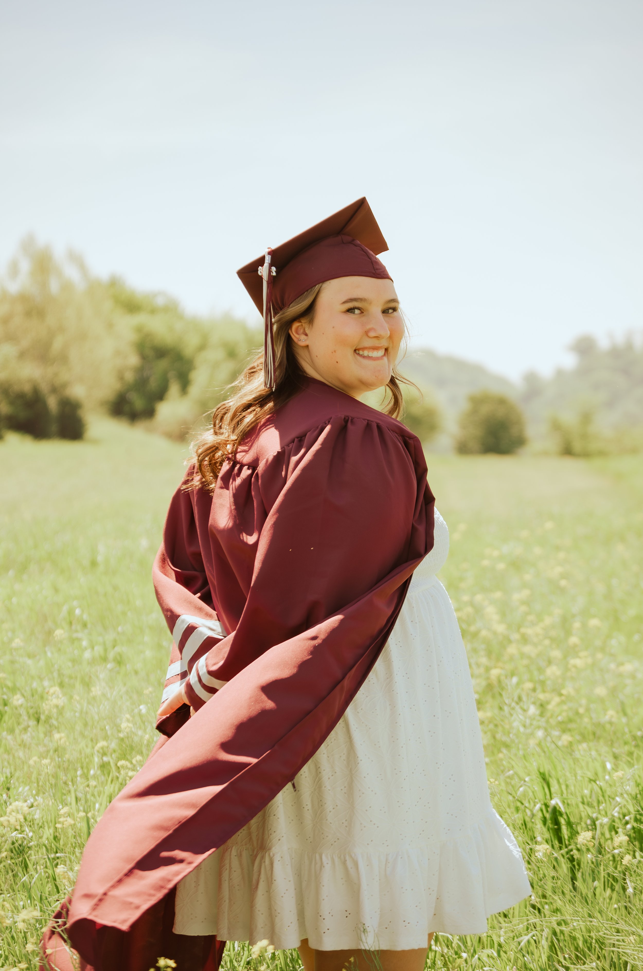 Graduate wearing cap and gown during golden hour portraits in Knoxville Tennessee