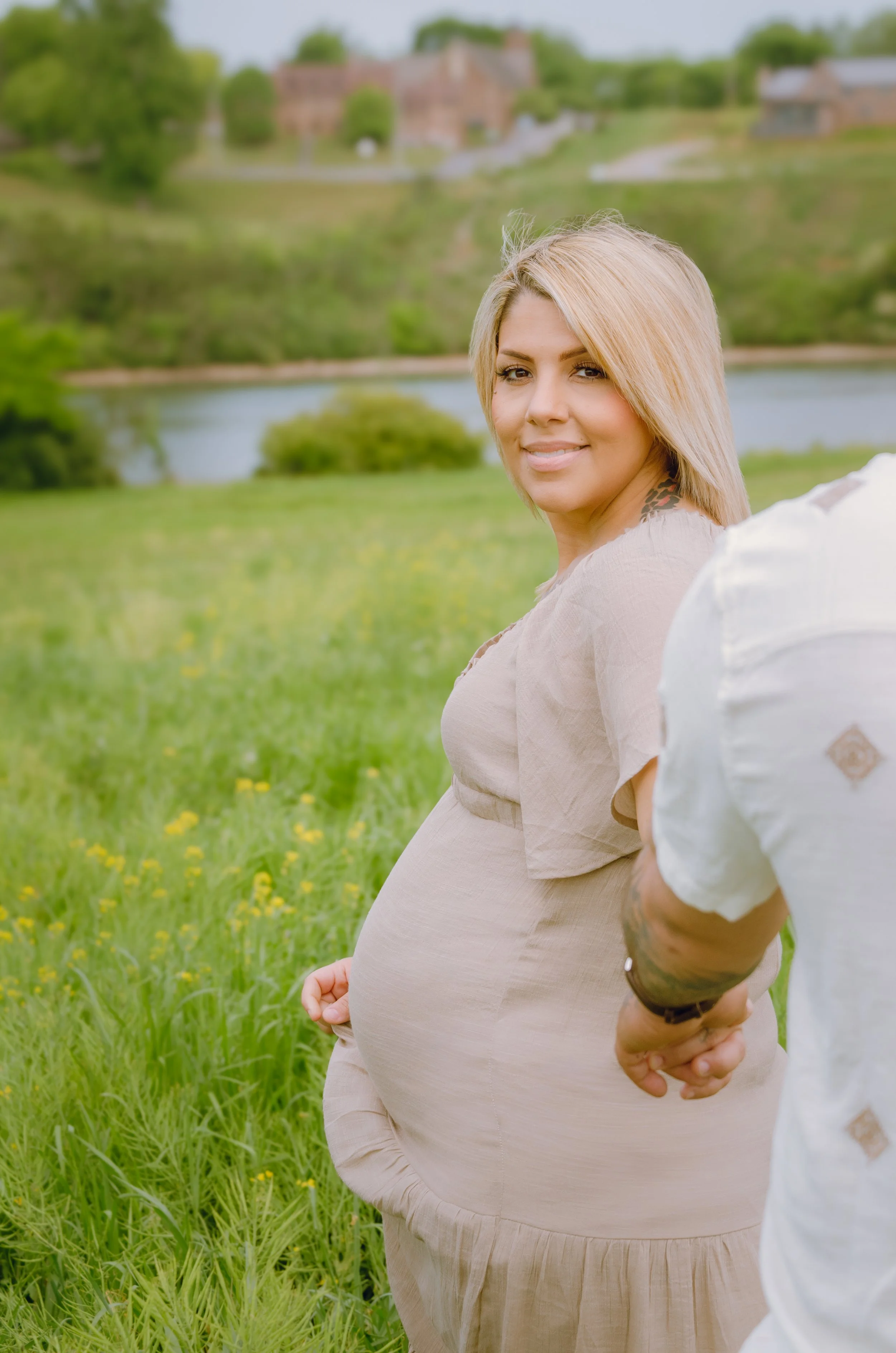 Expecting mother standing in a wildflower field during a maternity photoshoot in Knoxville Tn
