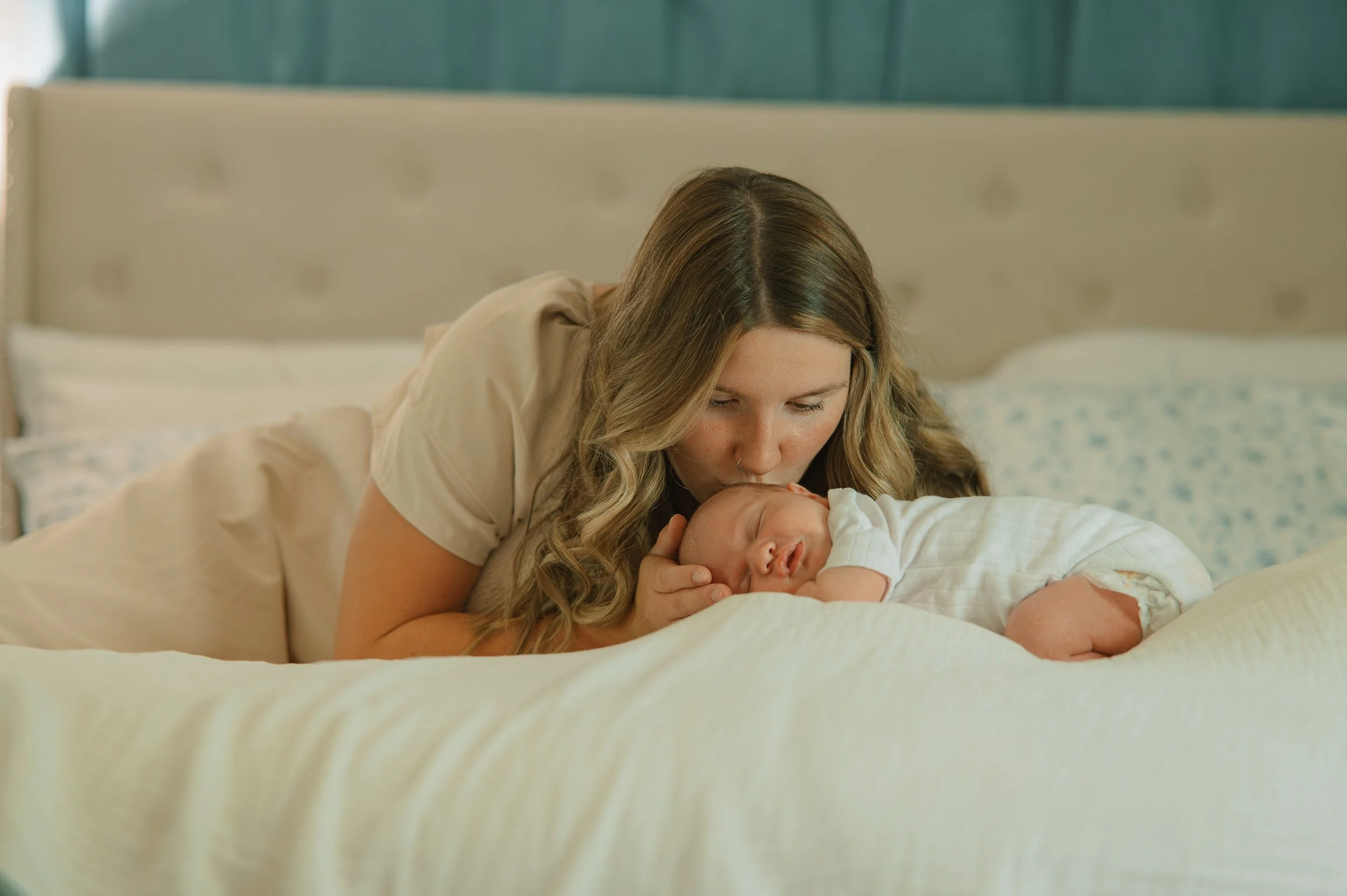 Natural in-home newborn photography featuring parents and their new baby