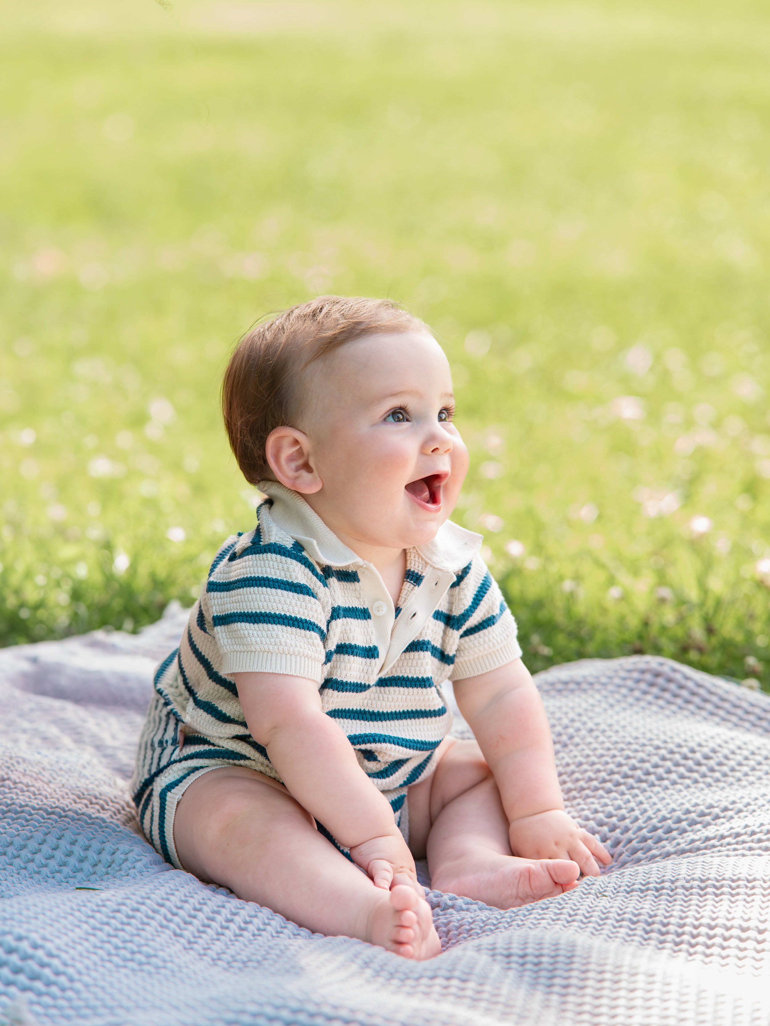 Family photography session in Maryville with active kids running and parents holding newborn