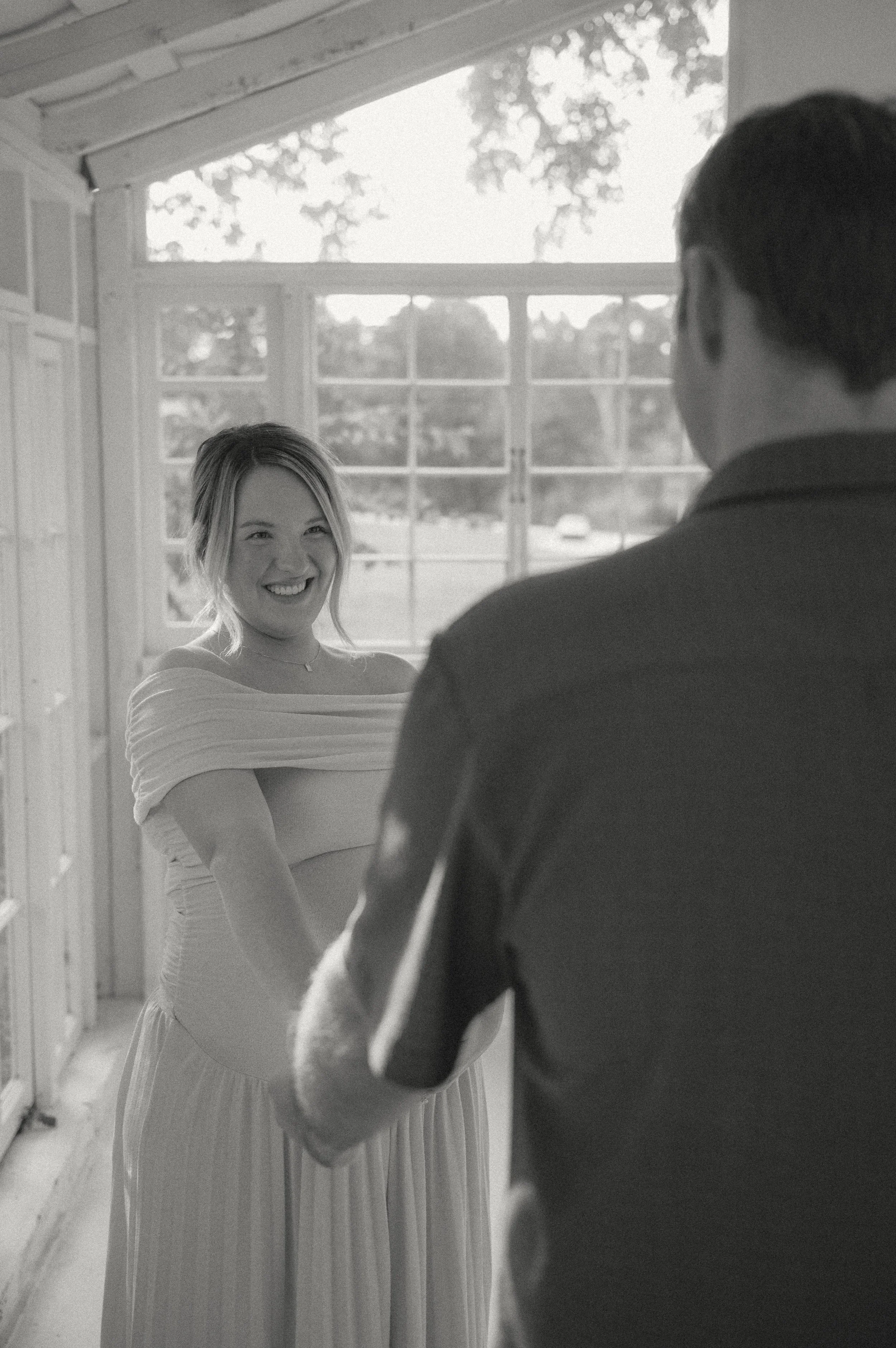 Maternity session with mom and dad smiling at each other at Holmstead Studio in Knoxville Tn