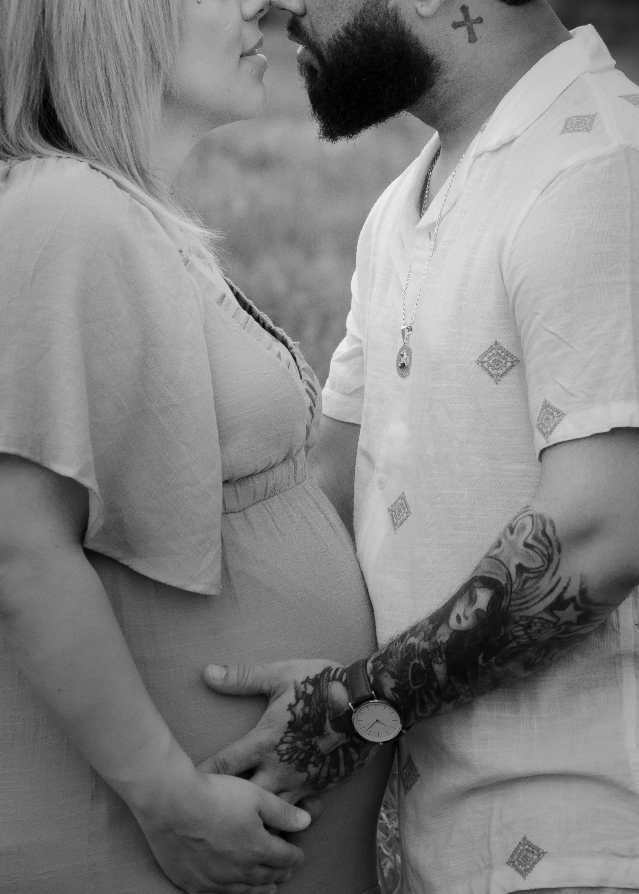 close-up of an expecting couple touching foreheads, hands on her baby bump, during a maternity session at UT Research, Knoxville outdoor maternity photographer