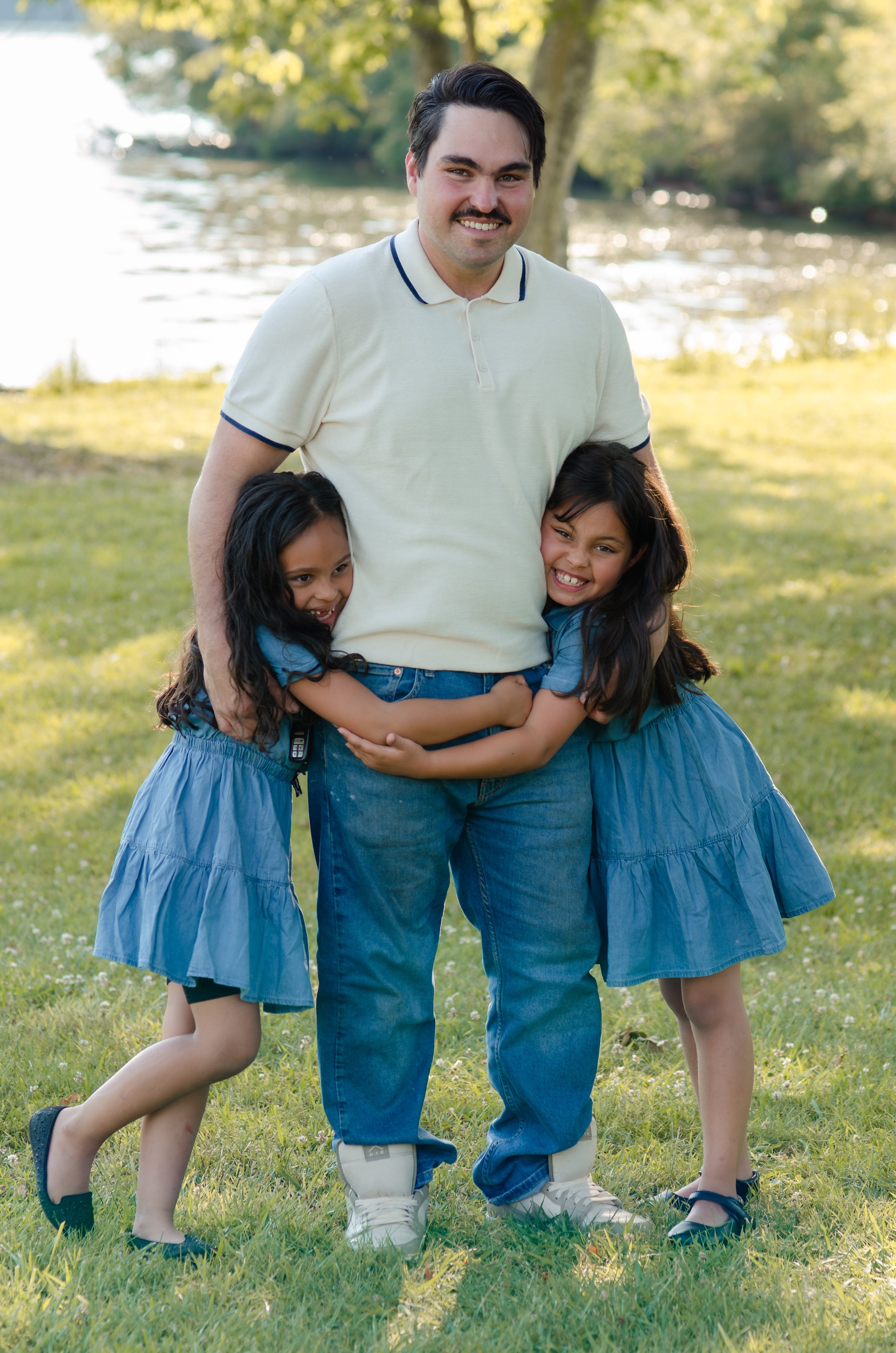 Knoxville family photographer capturing playful moments with little kids and newborn