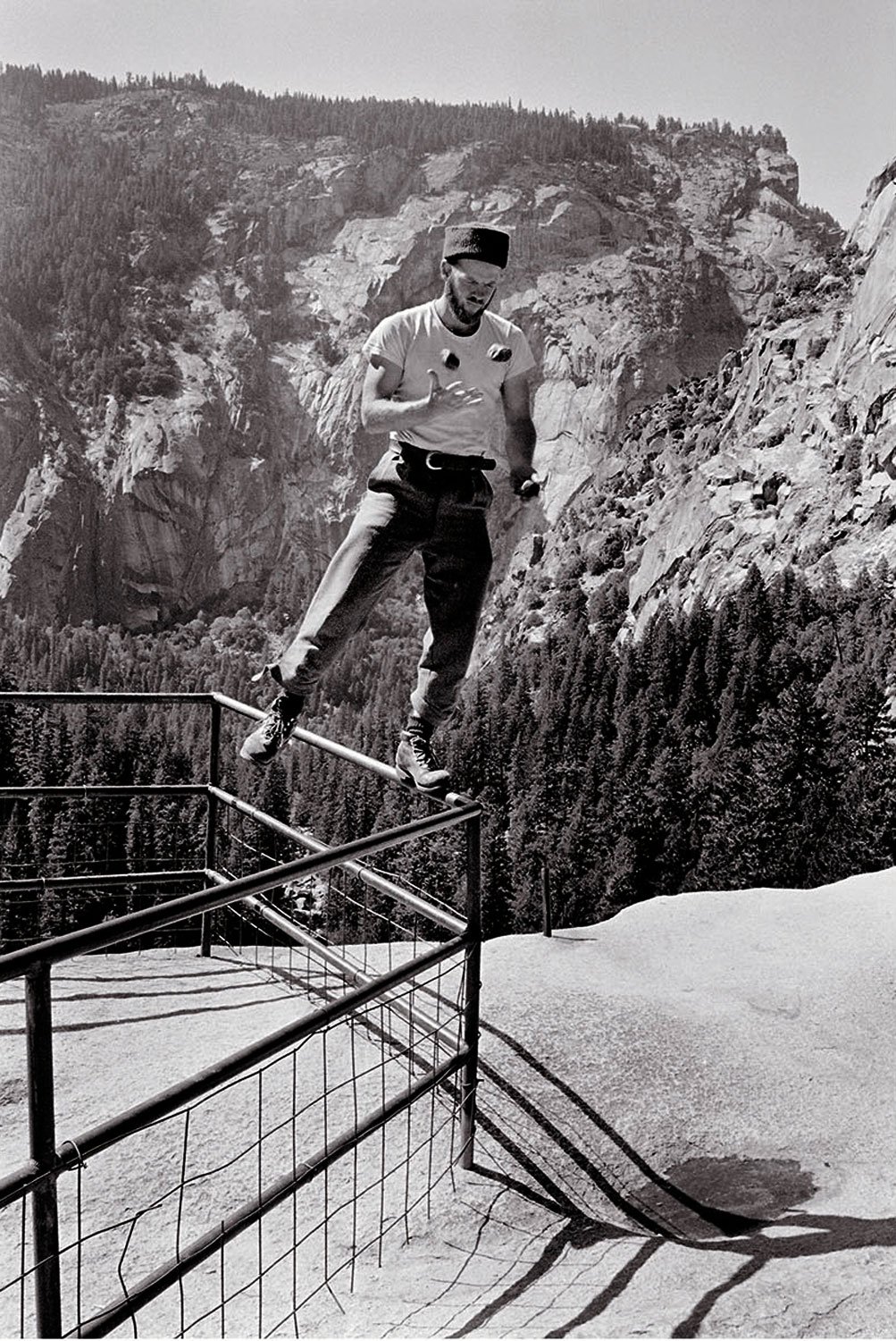 All the World’s a Stage, 196?. Chuck Pratt amuses himself while walking the railing at Yosemite Point, California. Easily one of the most bold and talented climbers during the Golden Age, Chuck helped usher in the 5.10 free climbing grade and wrote e