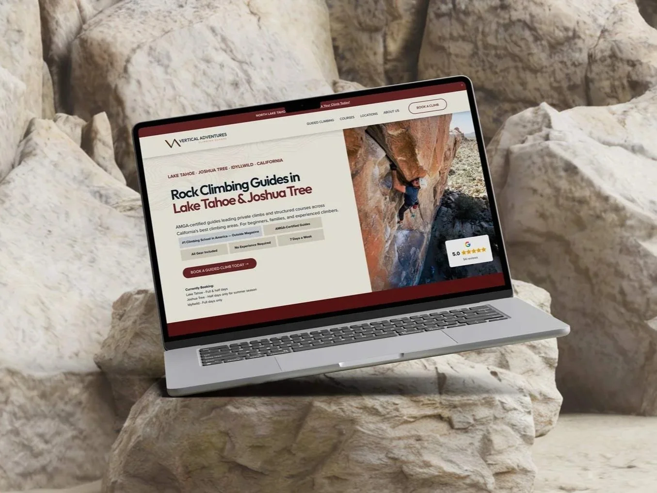 A laptop displaying a rock climbing guide website, resting on a large stone in a rocky outdoor setting with white rocks in the background.