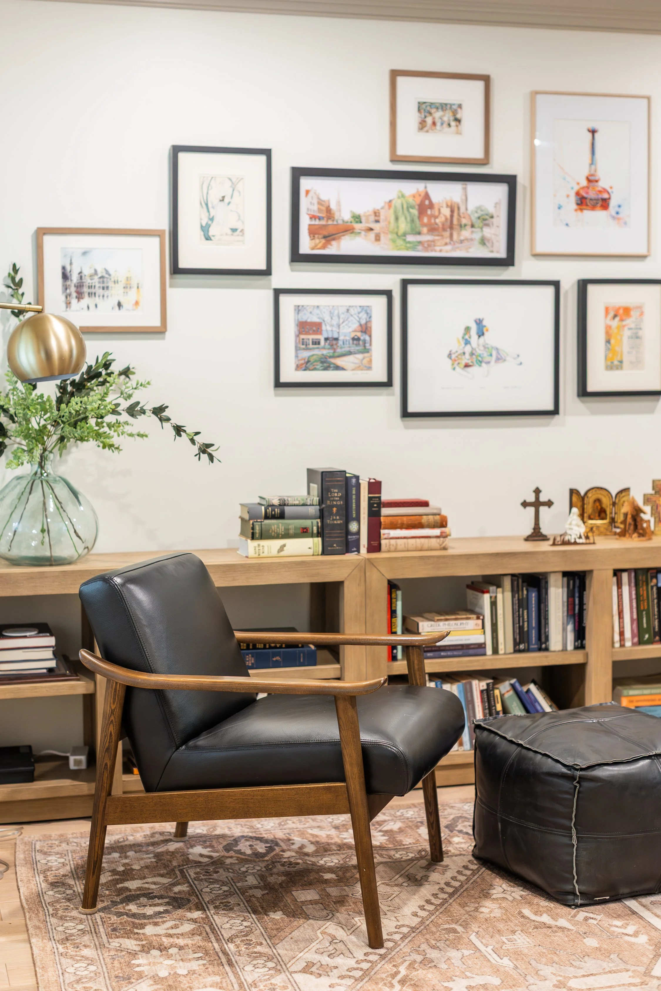 Gallery walls can start small and grow as your collection grows. Repeat frames in black, brass, and brown to add interest.