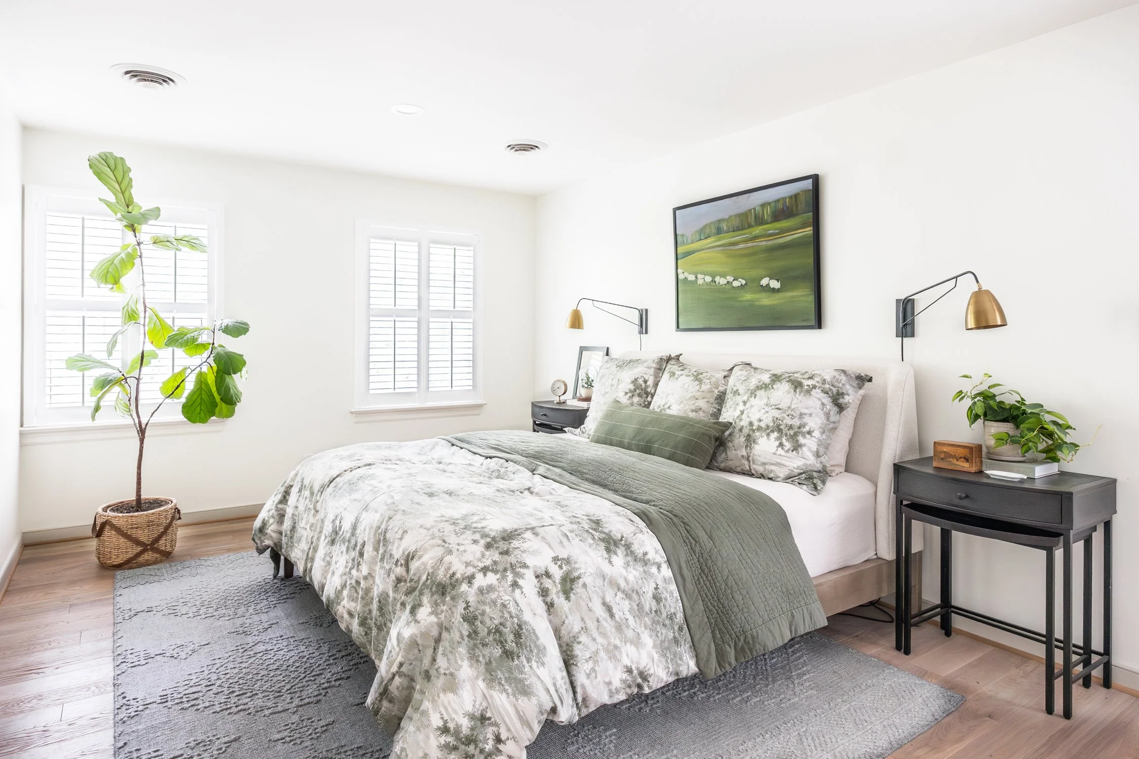 Bright bedroom with color pallette of green, gray, white. Adding black to any room adds sophistication and looks layered and elevated.