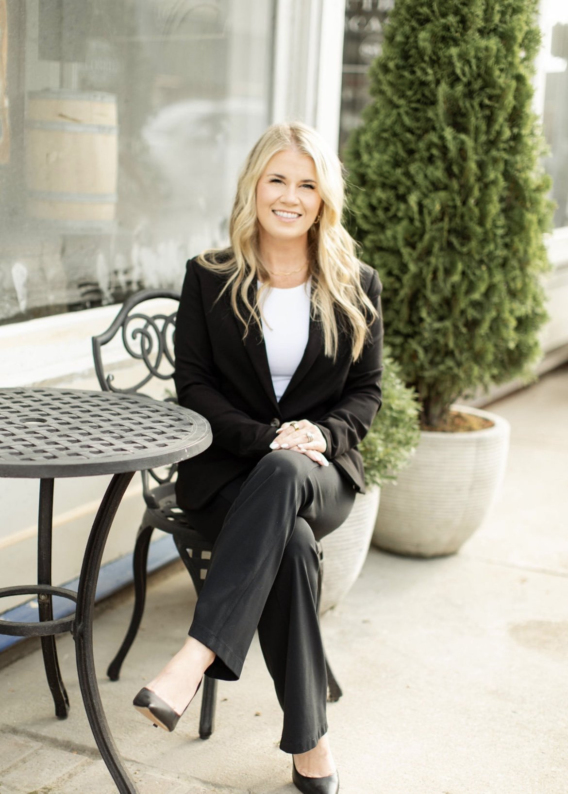 Dr. Lana Henry, licensed professional counselor, seated outdoors, smiling in professional attire.