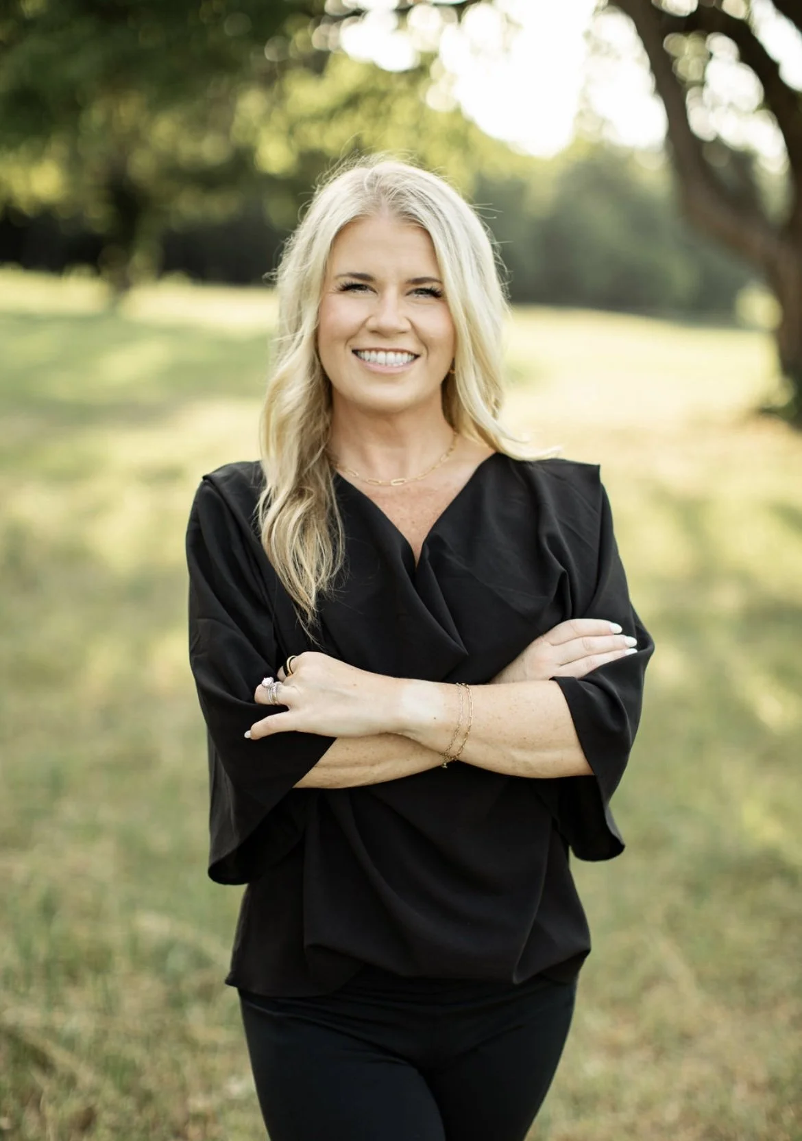 Dr. Lana Henry, trauma-informed therapist and speaker, outdoors in professional attire.