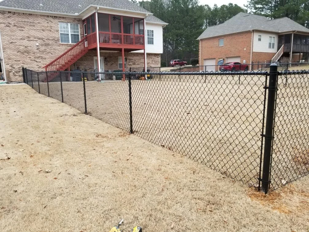Black coated chain link fence.