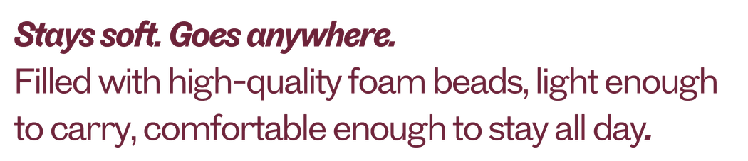 Text advertisement for a pillow, emphasizing softness, portability, high-quality foam beads, and all-day comfort.
