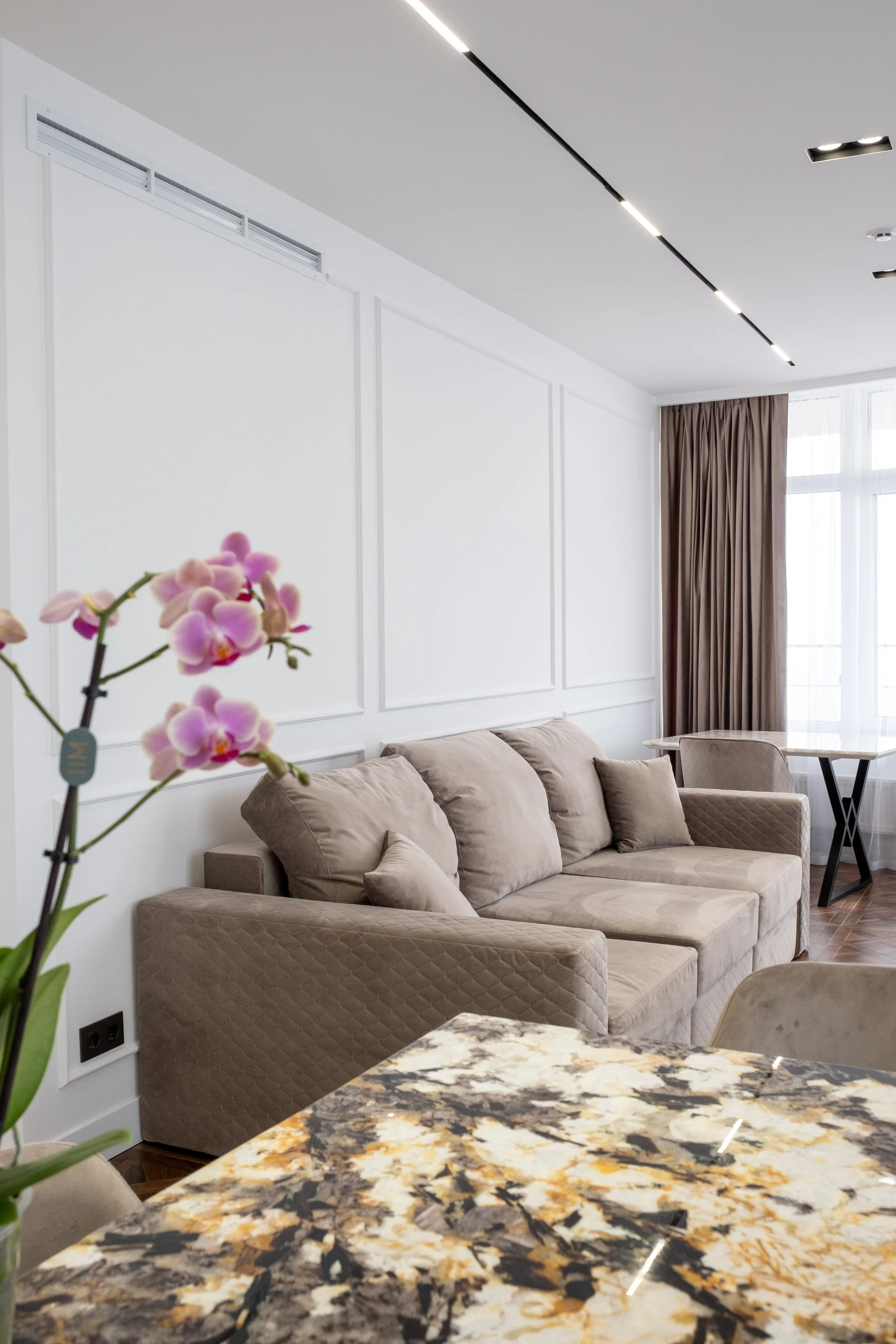 Interior photography of modern living room, beige sofa, marble table, natural light, neutral interior, Niagara region