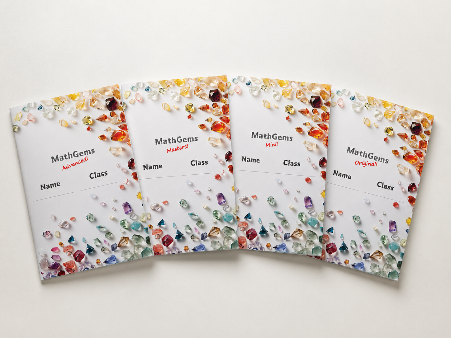 Four educational books titled MathGems with colourful gemstone illustrations on the covers, labelled 'Advanced!', 'Masters!', 'Mini!', and 'Original!', spread out on a white surface.