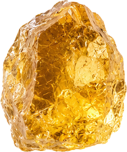 A large, rough, amber-colored gemstone with complex internal structures.