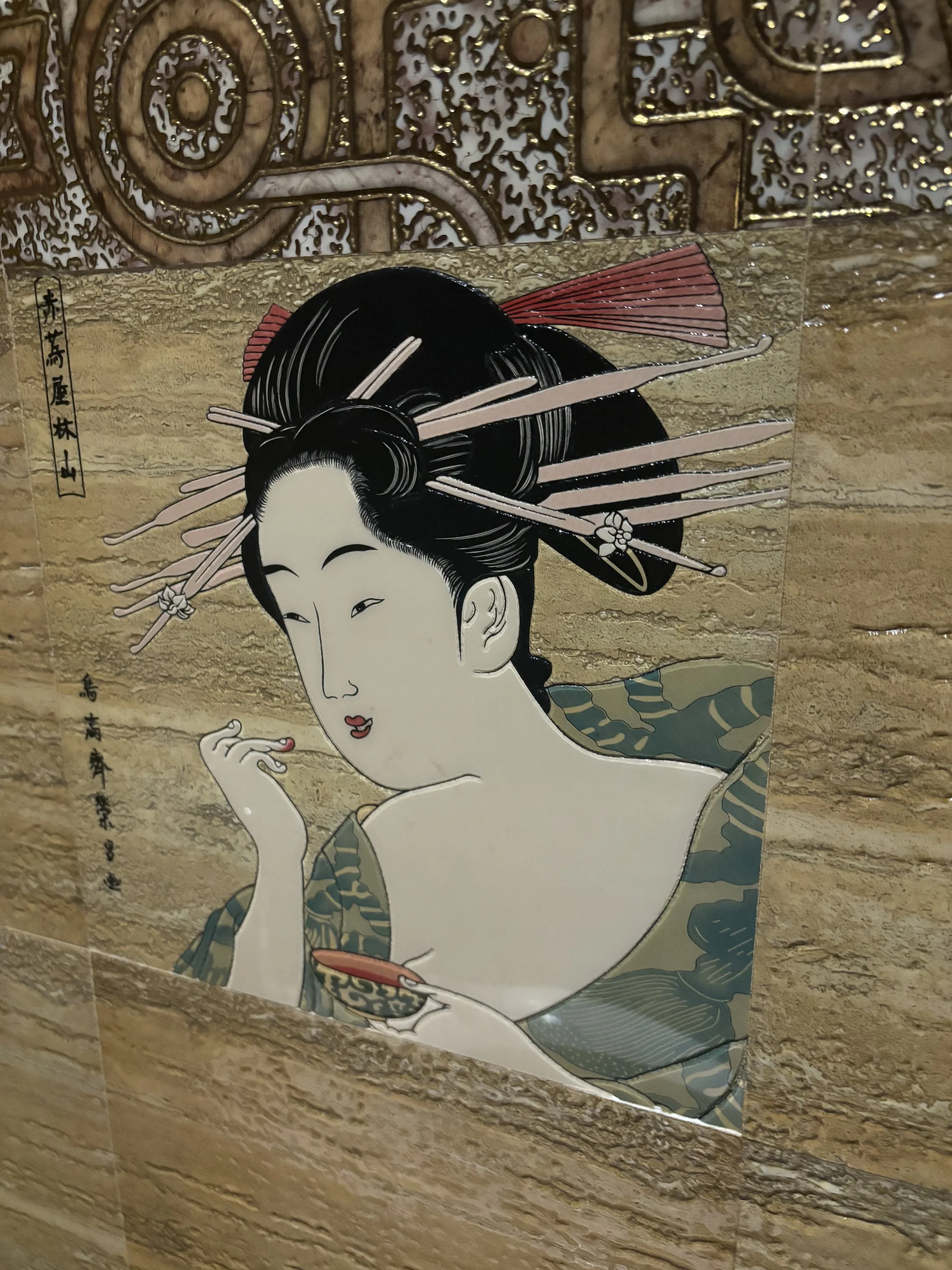 Traditional Japanese print of a woman with styled hair adorned with hairpins and ornaments, wearing a kimono, with her eyes slightly closed and her right hand gently touching her face.