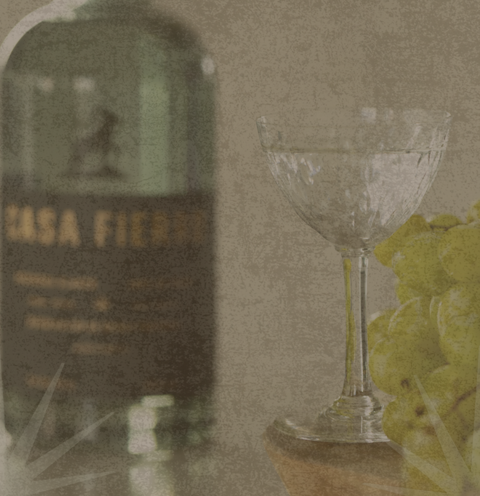 A clear wine glass with a long stem and a rounded bowl, placed on a surface next to a bunch of green grapes. In the background, there is an archway leading into a room with a lighthouse-shaped object on a table.