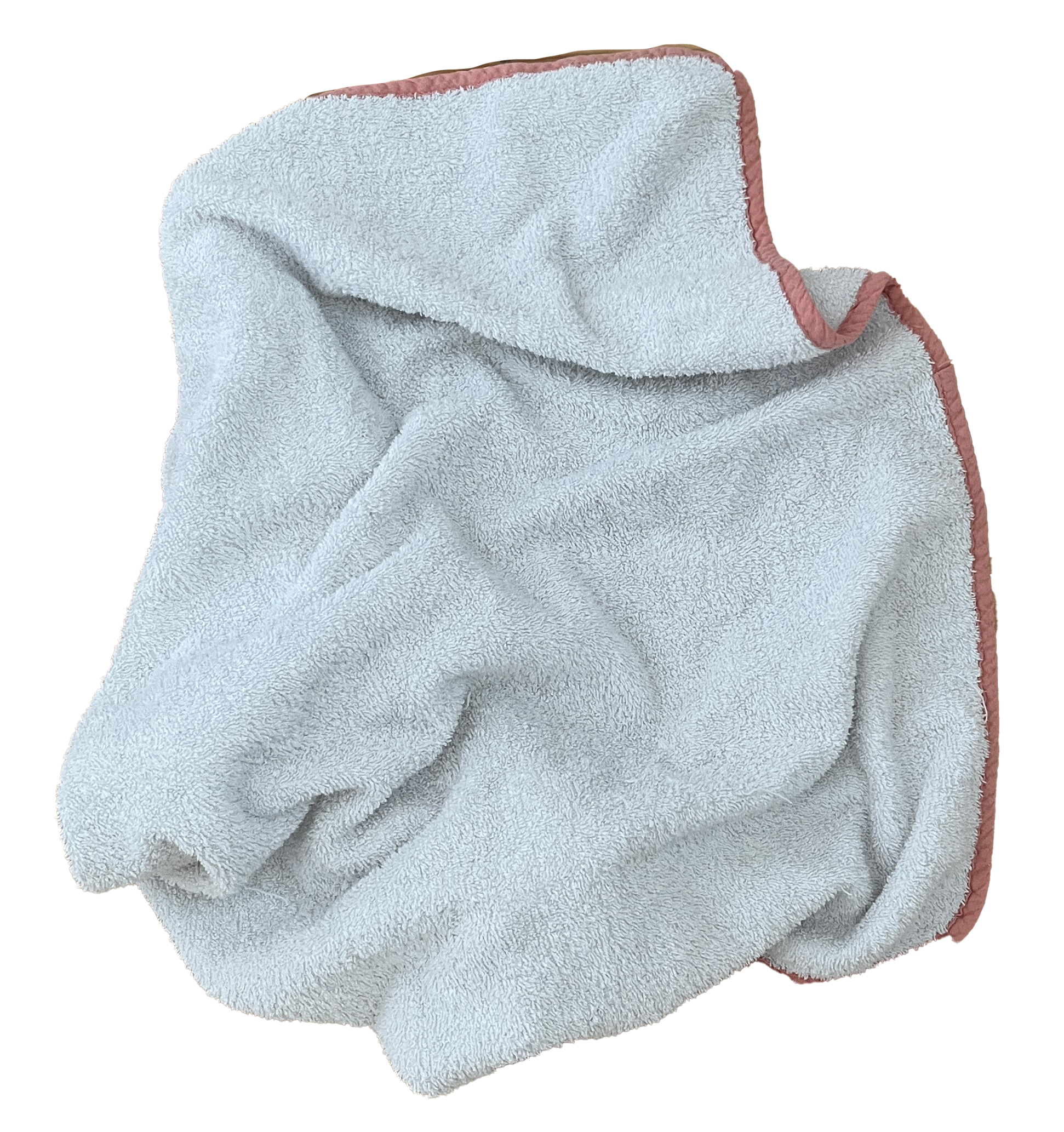A white terry cloth towel with pink edging, folded over itself, against a black background.