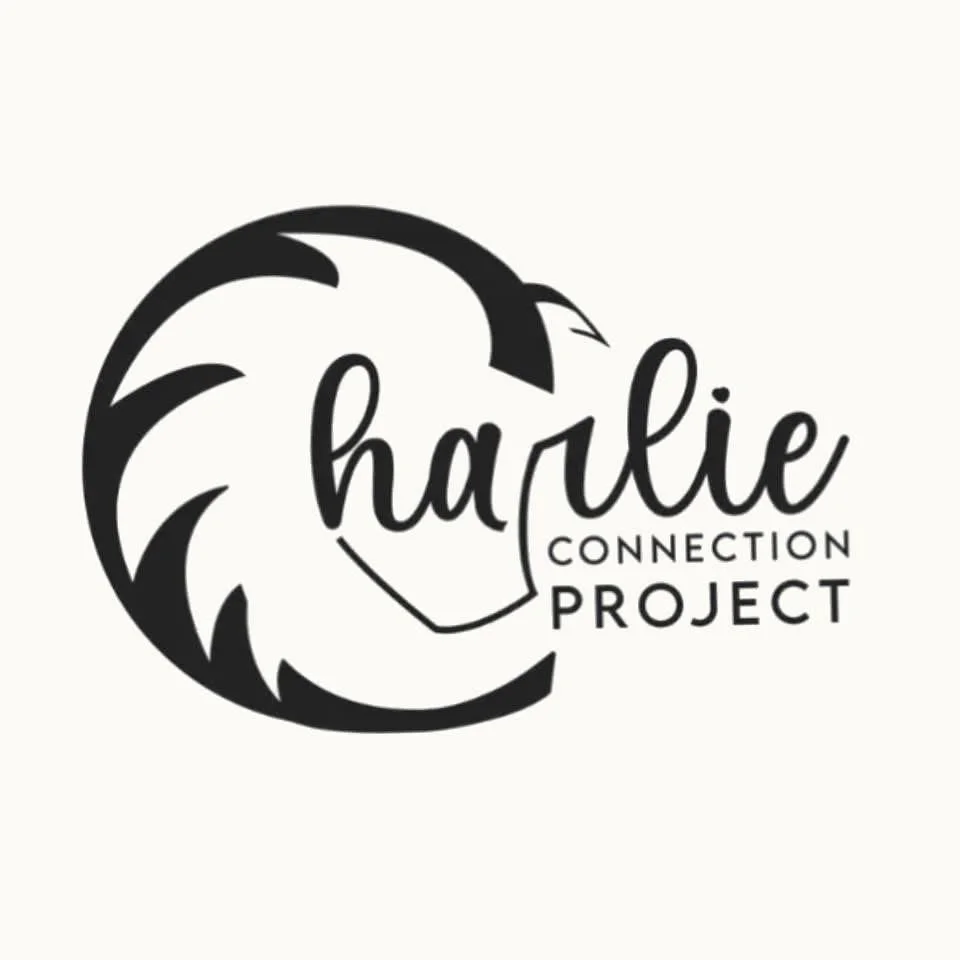 Logo for Charlie Connection Project, featuring a stylized lion's face outline and the text 'charlie CONNECTION PROJECT' in black.