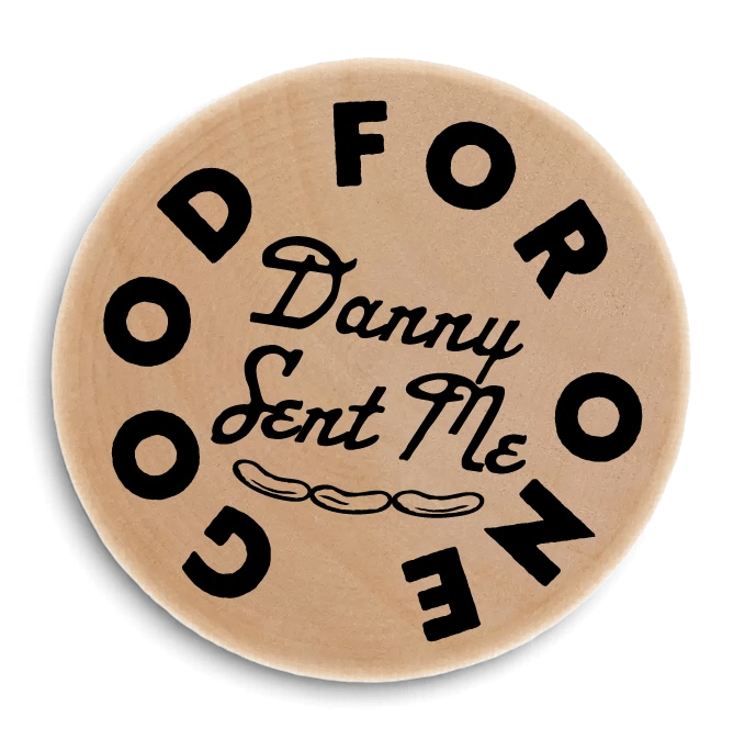 Wooden badge with the text "Good for" and "Danny Sent Me" in black, with a decorative line underneath.