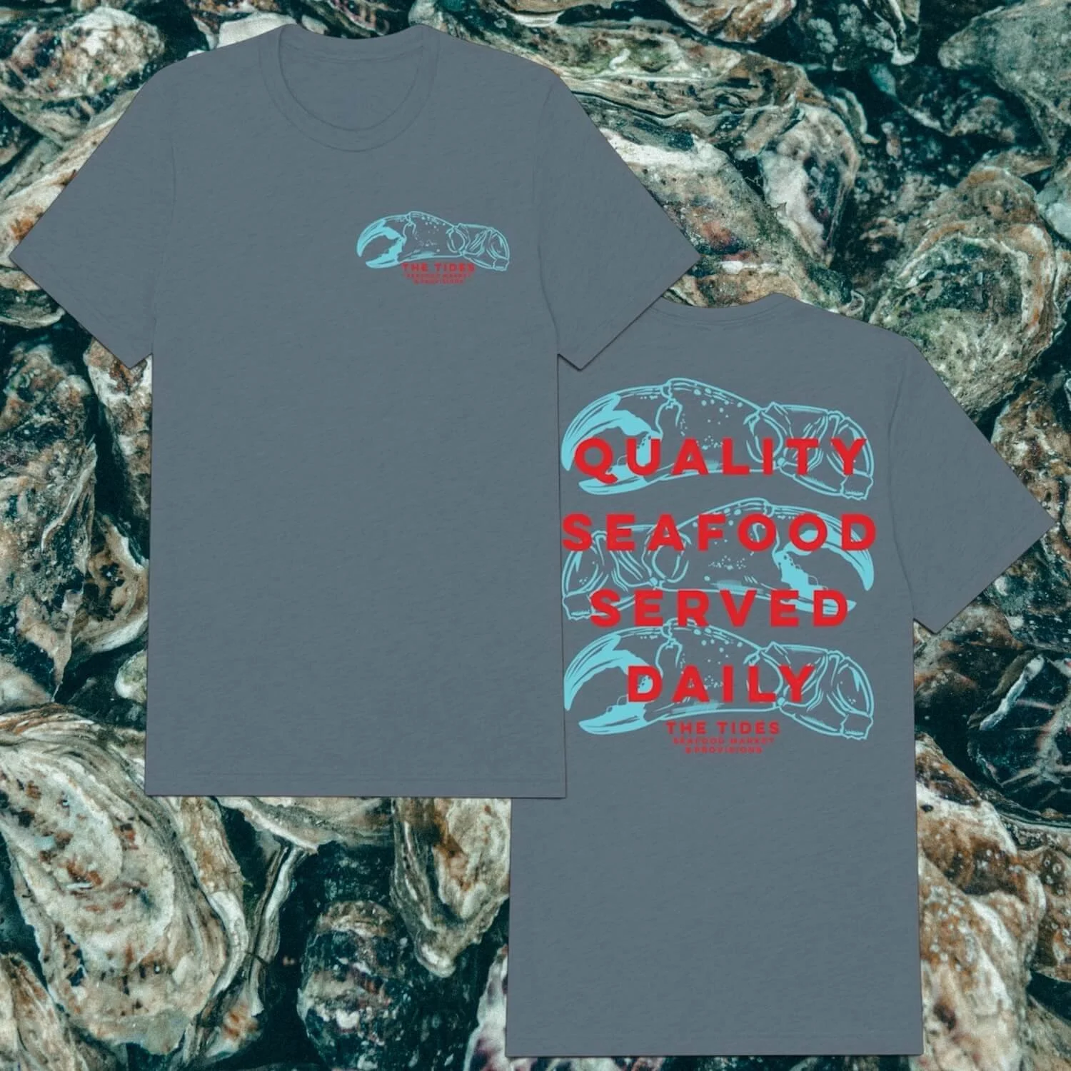 Gray T-shirt with blue crab illustration and red text reading 'Quality Seafood Served Daily' on a background of oysters