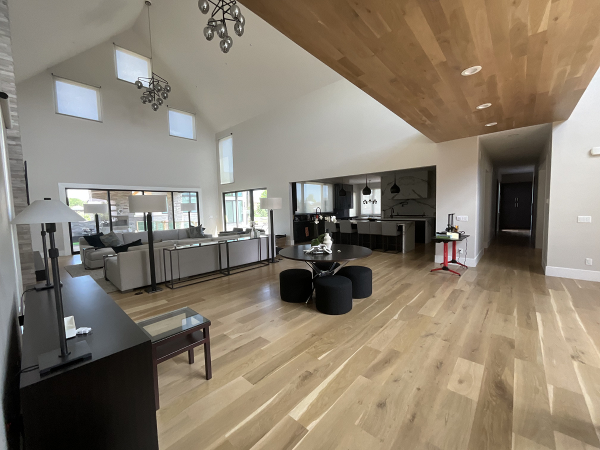 Modern luxury home interior with vaulted ceilings, custom wood ceiling detail, neutral wall colors, and professionally finished interior painting in contemporary Colorado residence.