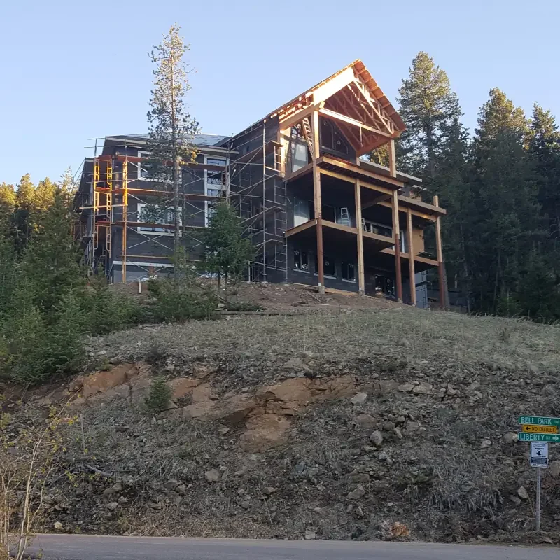 New construction painting project for a custom mountain home in Colorado showing exterior finish work on a newly built residential structure.
